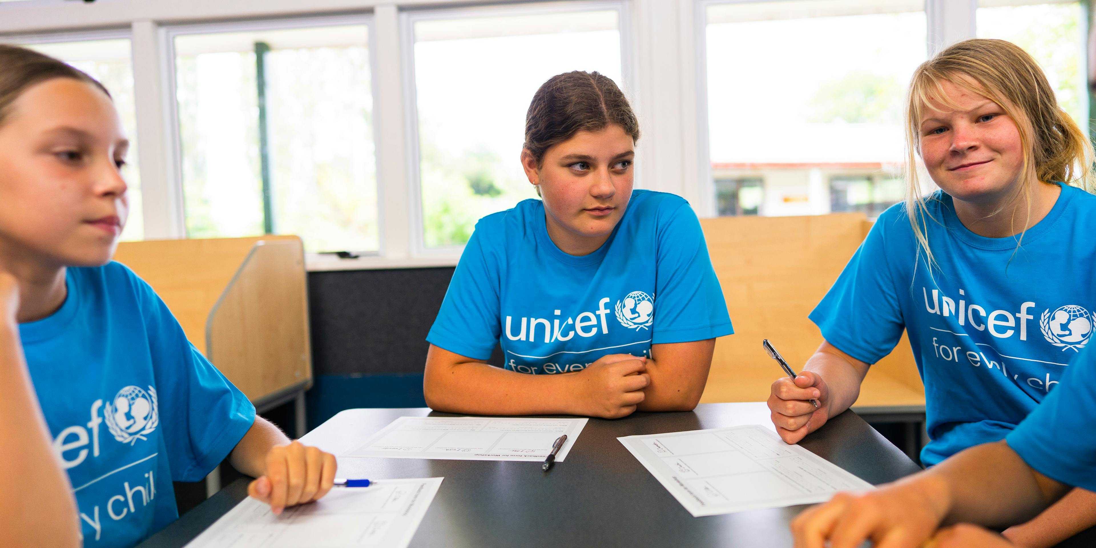 A group of young girls in a New Zealand school learn about their rights on World Children's Day.