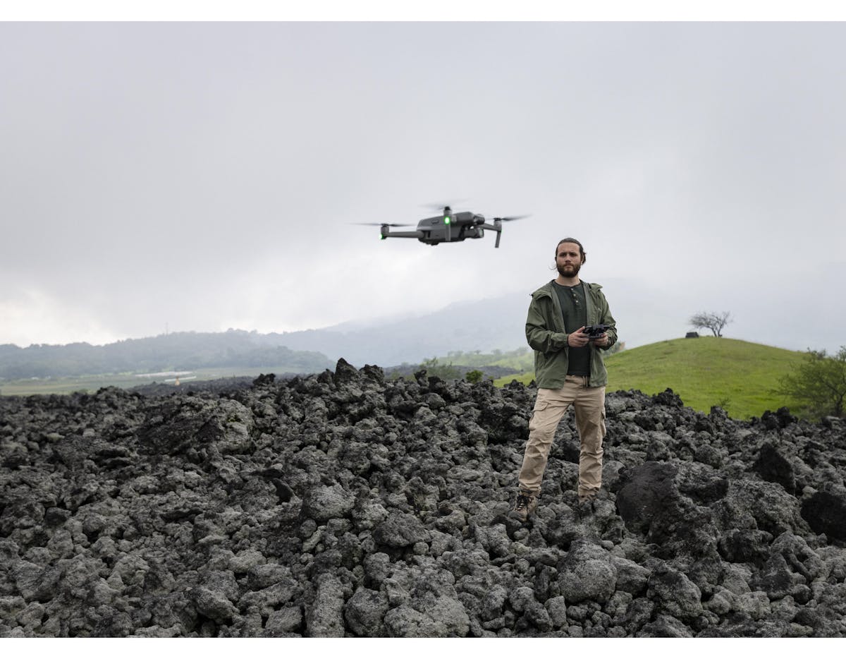 Dan Alvarez, drone engineer from the company Aerobots in Guatemala and team member of the UNICEF-led Dronebots project, operates a drone in front of the landscape at Finca El Amate, Guatemala.