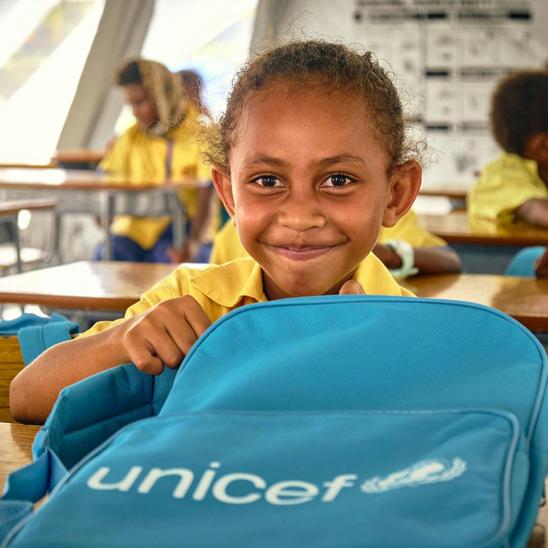 Keziah Vatoko (7 yrs) who is in class 3 at École Publique Centre Ville is excited to open her UNICEF backpack. "I am happy to be back in school and to meet my friends" says Keziah.