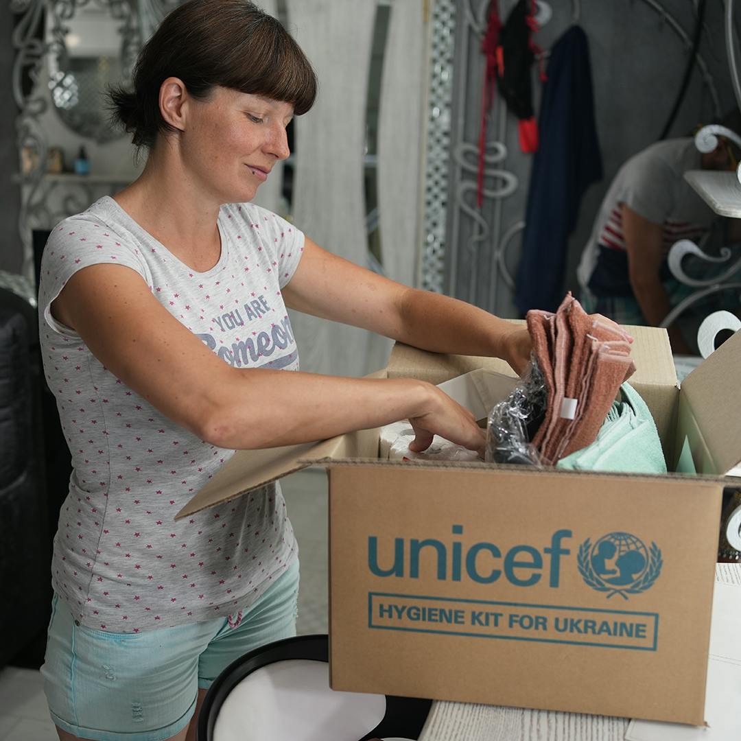 June 6, 2023, Chaika, Khersonska district, Ukraine. Kateryna, who was evacuated with her family from her home because of flooding, is looking through the humanitarian kit from UNICEF.