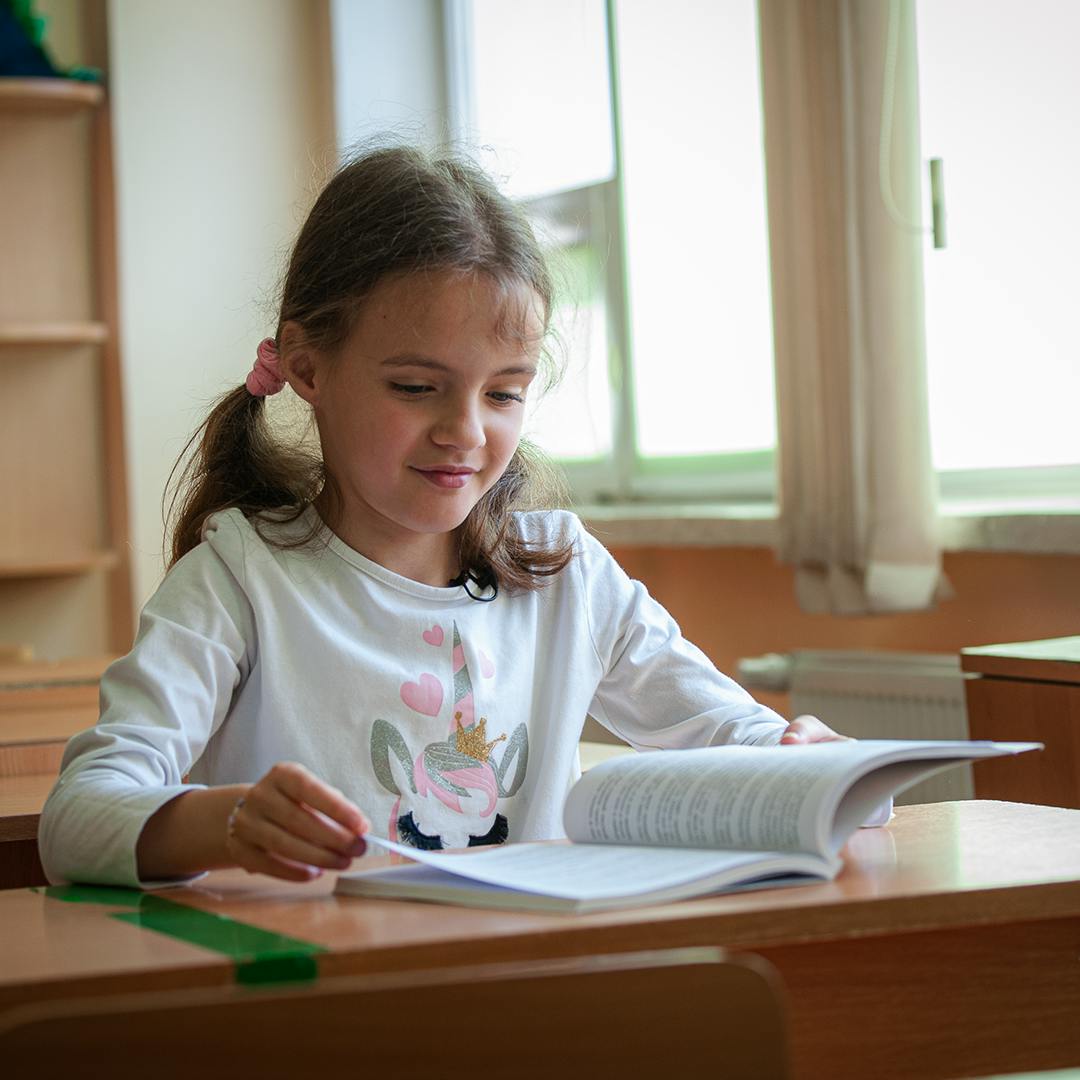 10-year-old Sasha sits at her desk on the last day of the school term at at a central city school in Chisnau, Moldova.