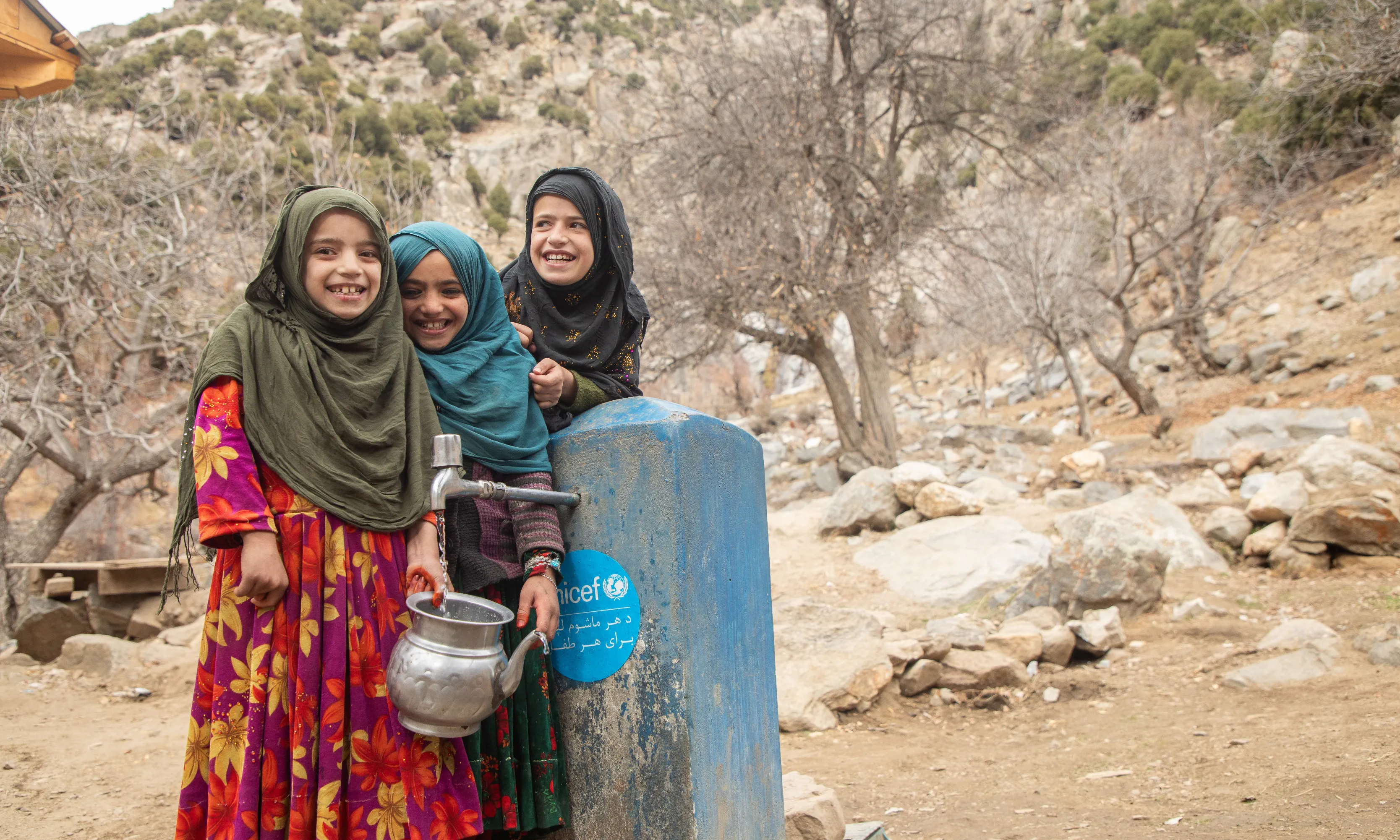 A lifetime supply of water - children fetch water from a new water tap in a village in Nuristan province's Kantiwa Valley in Afghanistan