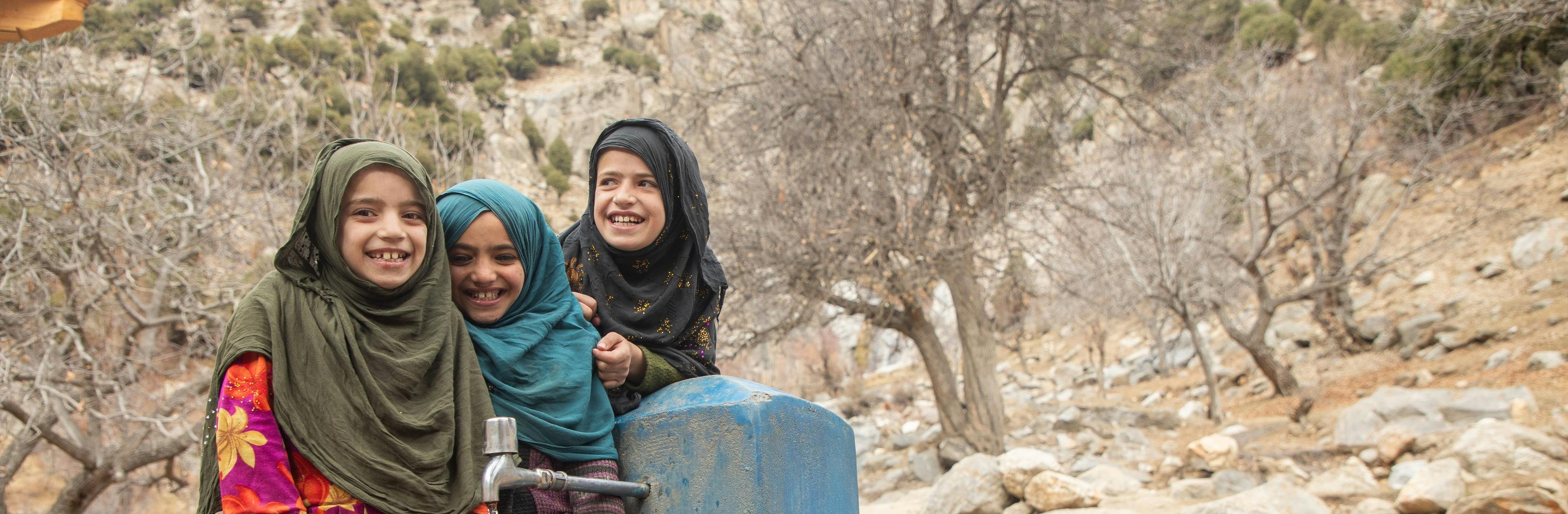 A lifetime supply of water - children fetch water from a new water tap in a village in Nuristan province's Kantiwa Valley in Afghanistan