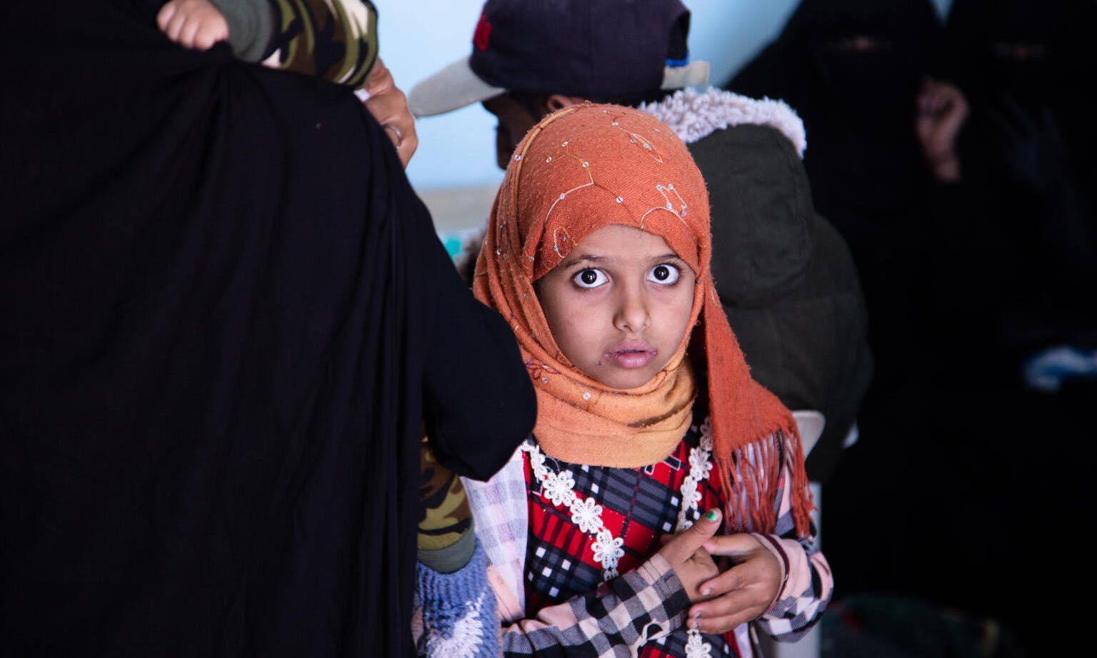A girl waits to be seen by a healthcare worker at the Jabal Ghawas Health Unit, in the Habour Dhulimah, Yemen. 