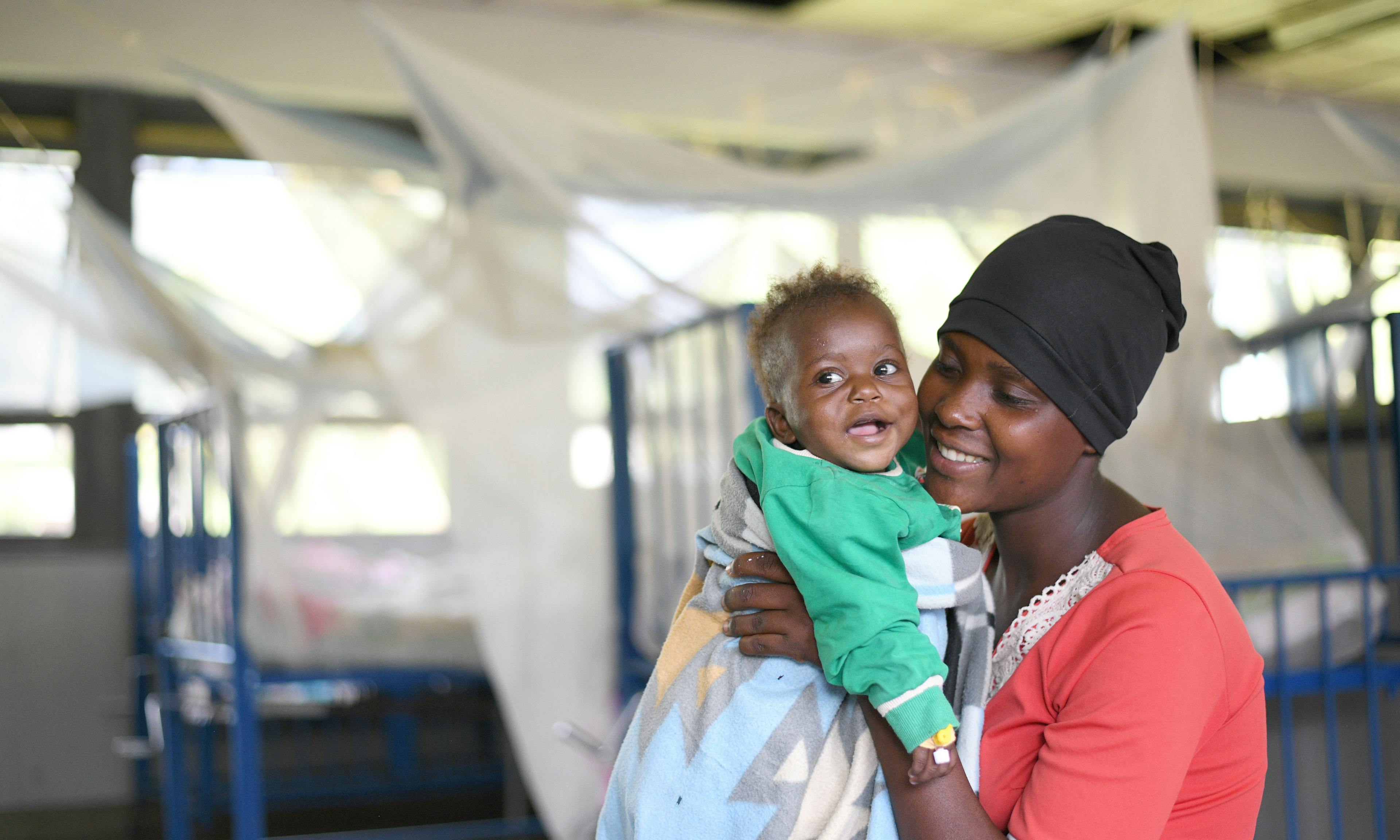 Akatukunda Jovat interacts with her ten months baby Amutuhirwe Traesure in the pediatric ward at Itojo hospital in Ntungamo district. The ward had no malaria case because the district implements Ministry of health and UNICEF interventions including mosquito nets among others in fight against malaria