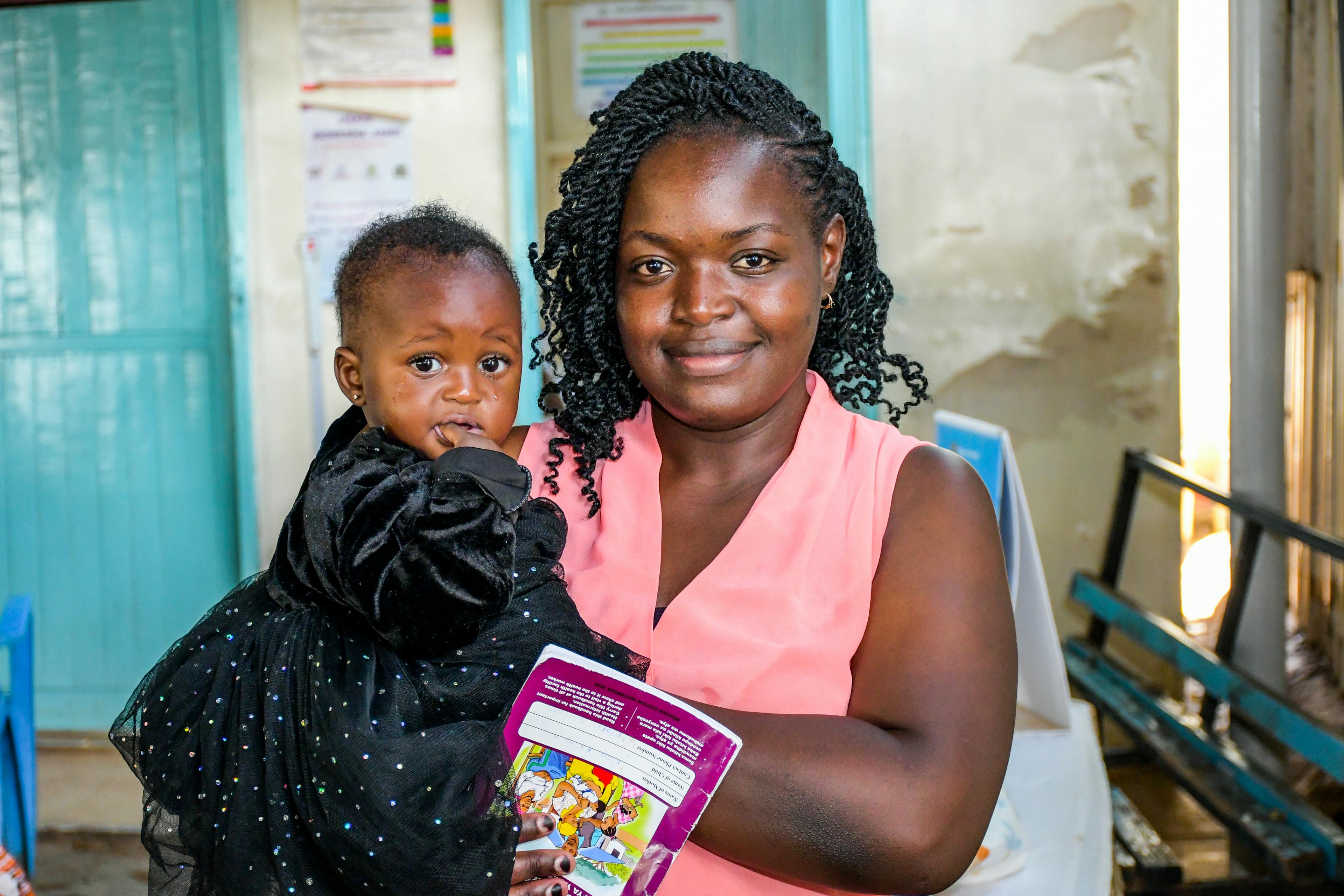 On 24 November 2023 in Kenya, 3-month-old Faith Nzilani is held by her mother, Rose Achieng, who has brought her to Kisumu County Referral Hospital to be vaccinated against malaria.