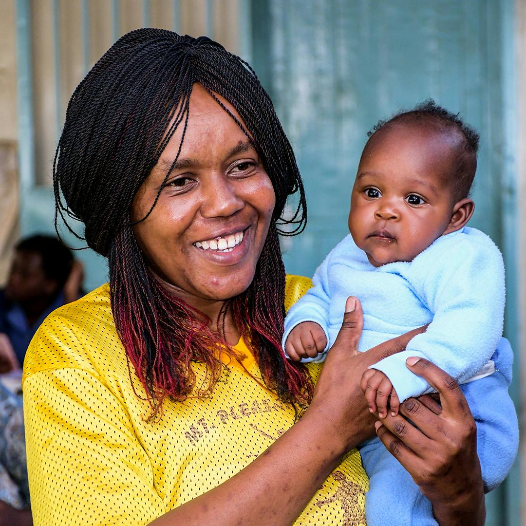 On 24 November 2023 in Kenya, 9-month-old Ann Mumo is held by her mother, Diana Achieng, who has brought her to Kisumu County Referral Hospital to be vaccinated against malaria.