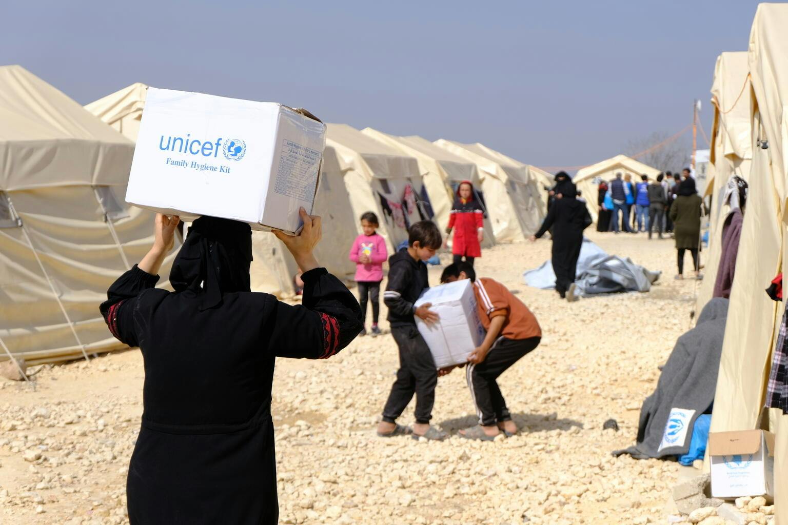Hope and Resilience in Türkiye and Syria - A women carries a UNICEF Family Hygiene Kit