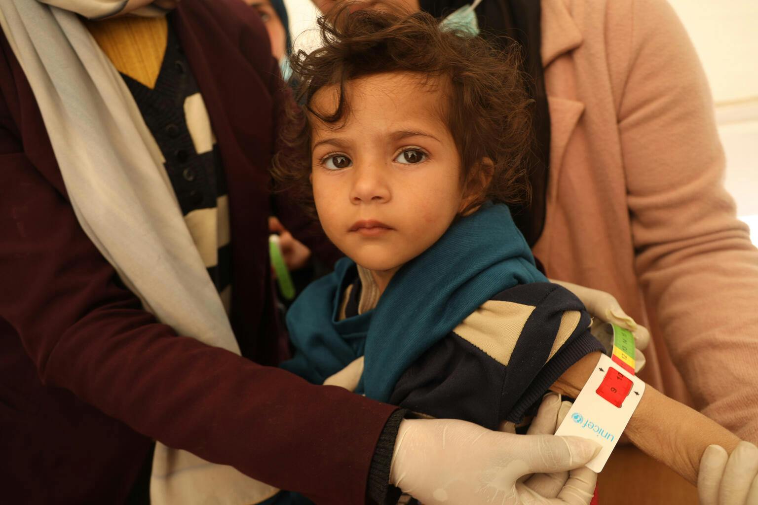 Catching signs of malnutrition early - a child in Gaza is screened for malnutrition using a MUAC band