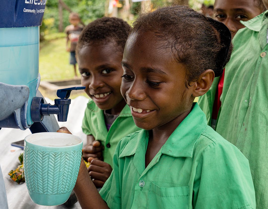 Students of Bangabulu school drinking clean water through their life straw system. Red Cliff, South Ambae, PENAMA, Vanuatu