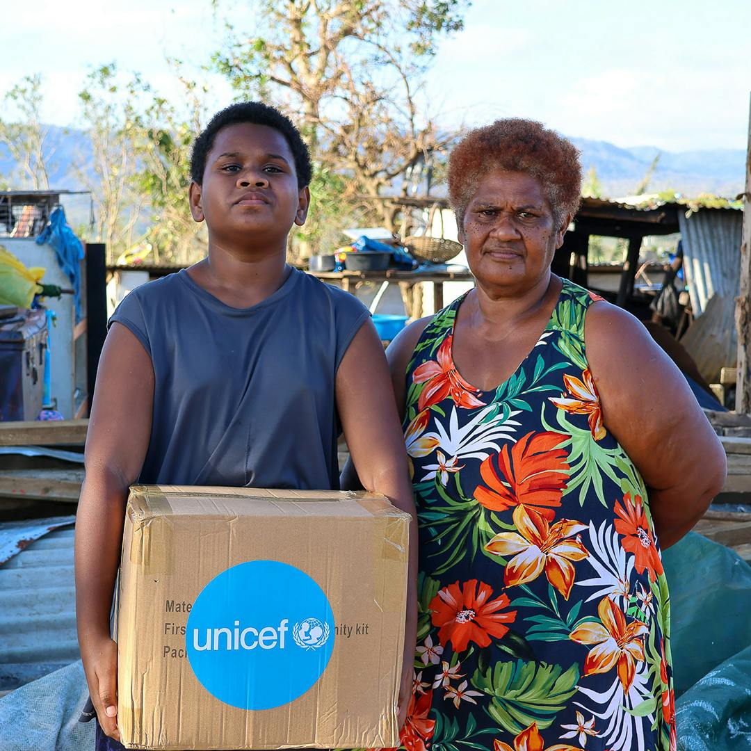 Jordan, 14, and his grandmother from Ohlen Nabanga community are one of the many families to receive the UNICEF dignity kits.