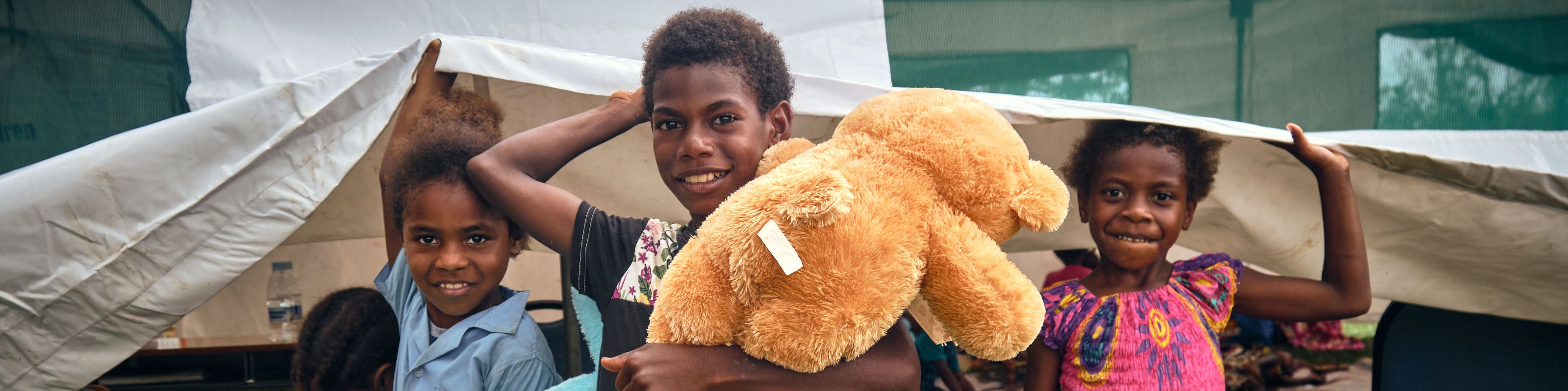 Children sheltering in a UNICEF tent after Cyclone Kevin and Judy in Vanuatu
