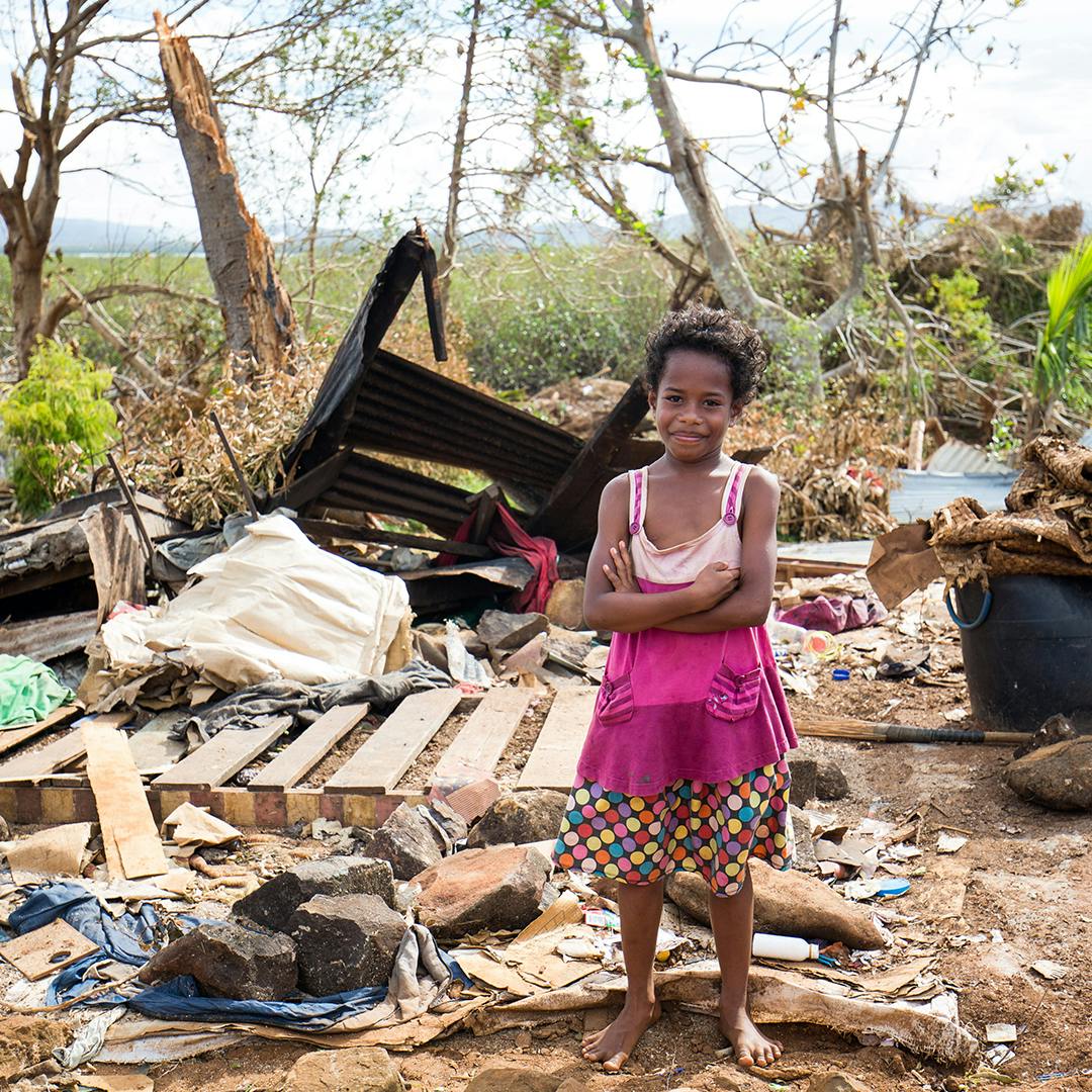 On 23 December 2020, 8 year-old Akanisi Divulo,stands in front of what is left of her house in Tavea Village - Bua.