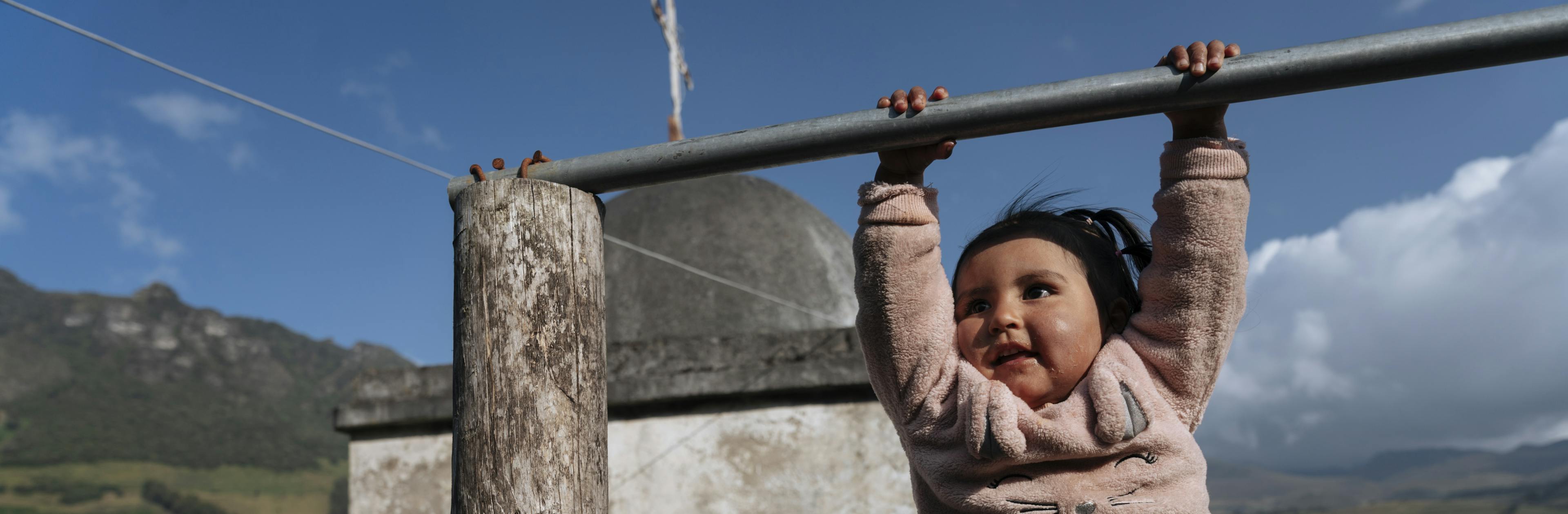 Latest UNICEF report shows 67 million children missed out on one or more vaccinations over three years. In Turugucho, Ecuador, Richard Yanez holds his 2-year-old daughter, Aysel, as she swings on a pole outside their home.