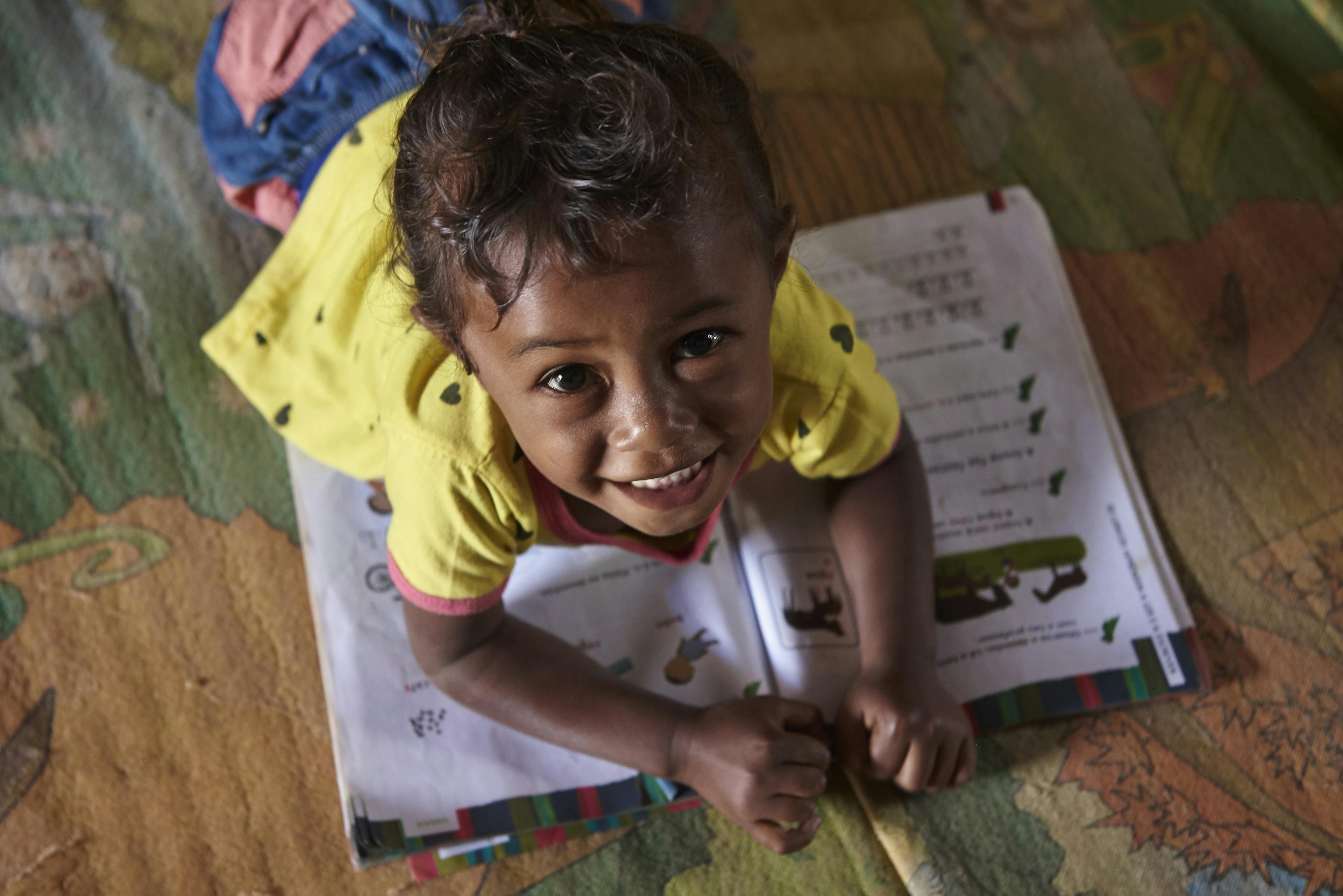 Education- A child reading a book in Timor-Leste