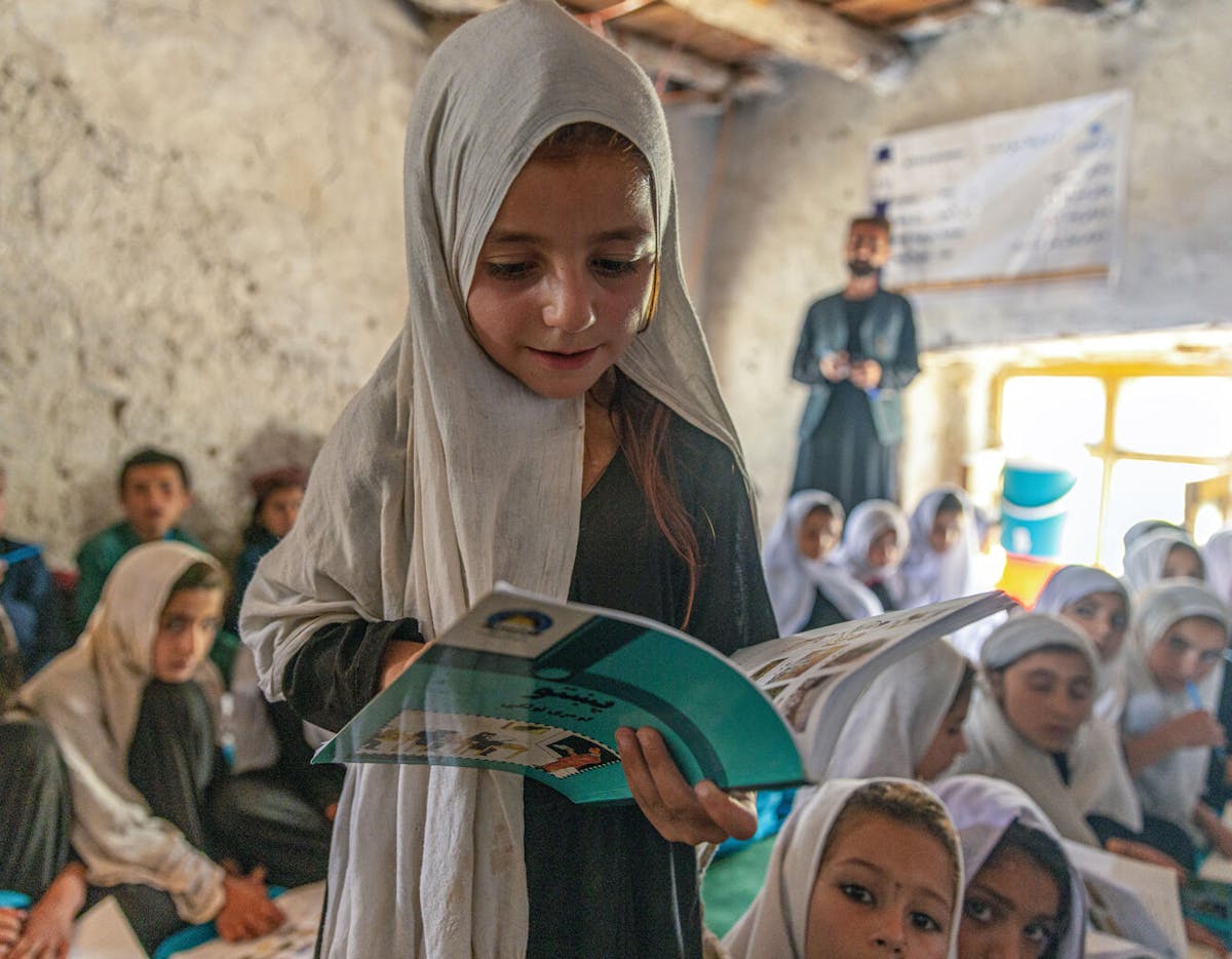 Global Parent- A little girl reads from her textbook in her new community-based education class in Spera District, Khost Province, Afghanistan. 