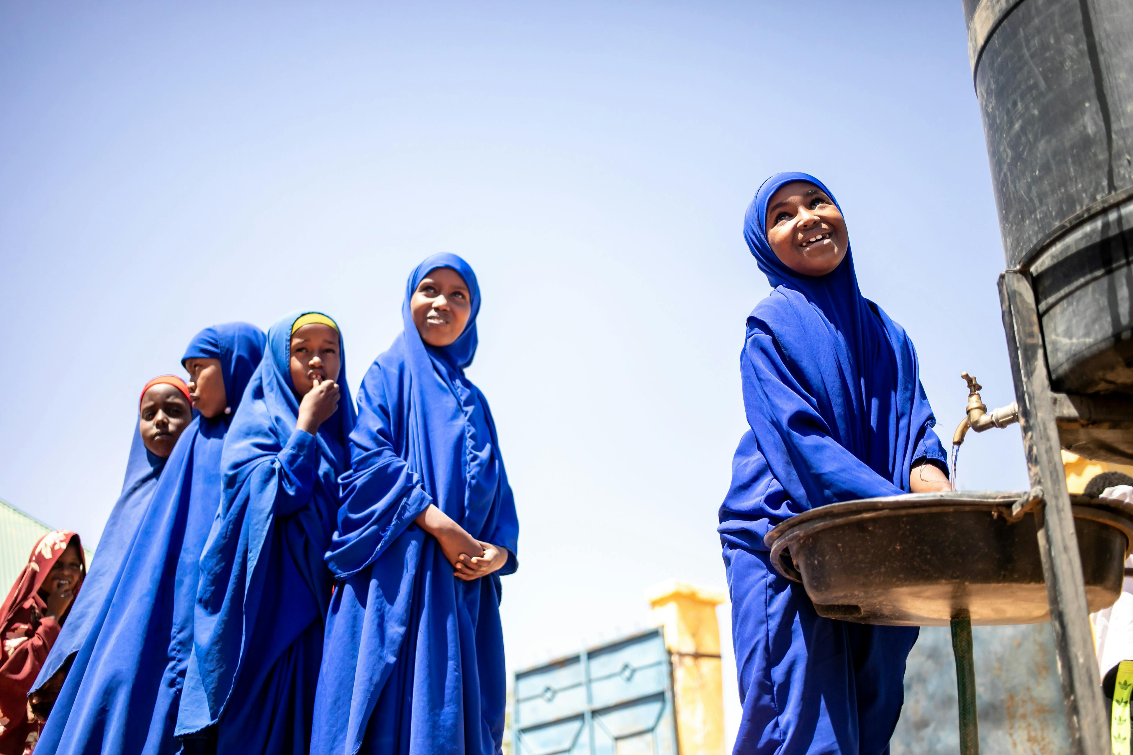 Corporate Partnerships- Students wash their hands in their Qansaxleey Primary and Secondary school playground in Dolow, Somalia