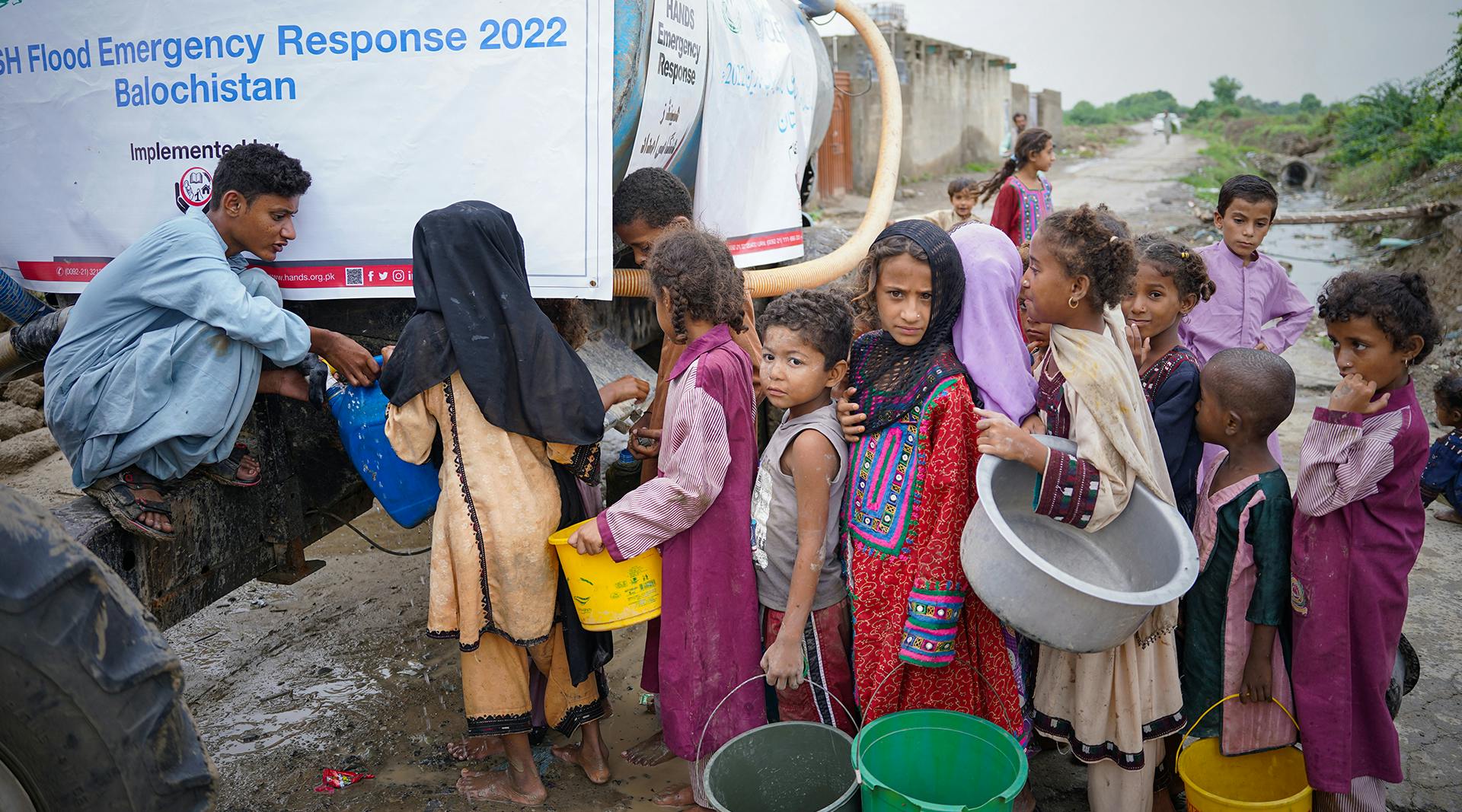 Children wait to collect safe drinking water delivered by UNICEF and partners to their village in Lasbela District, Balochistan Province, Pakistan.