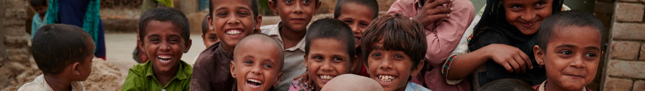 Horizontal strip from a photo showing cheerful children