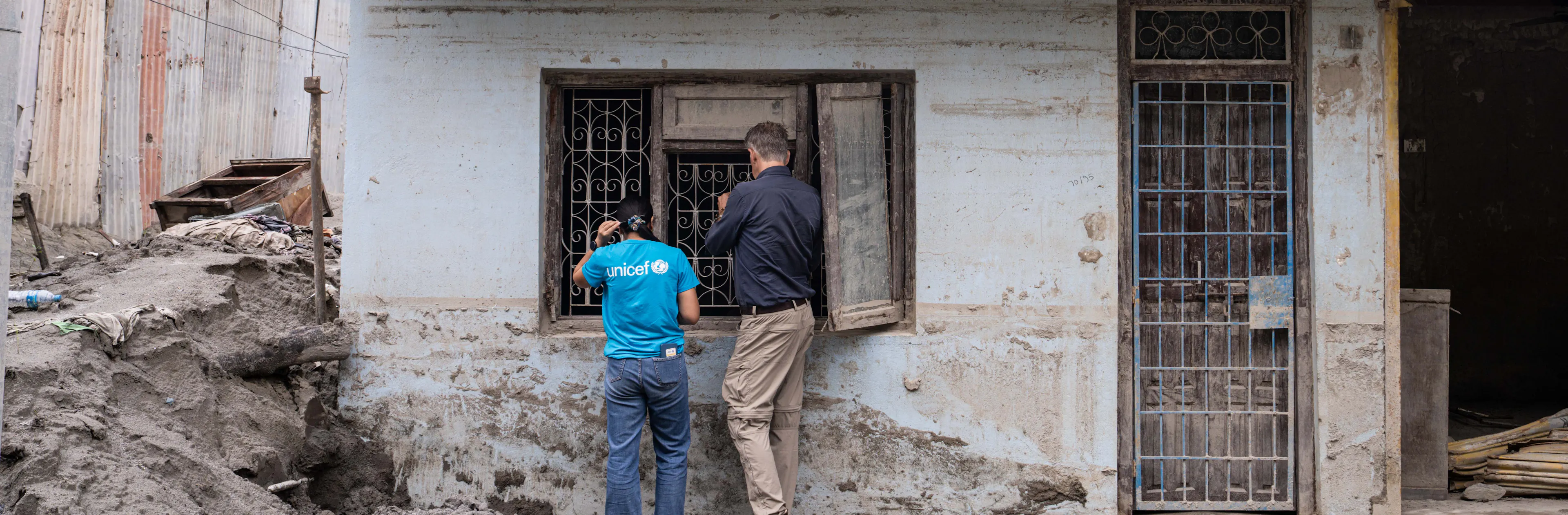Spokesperson James Elder and a UNICEF staff member survey damage in Nepal.
