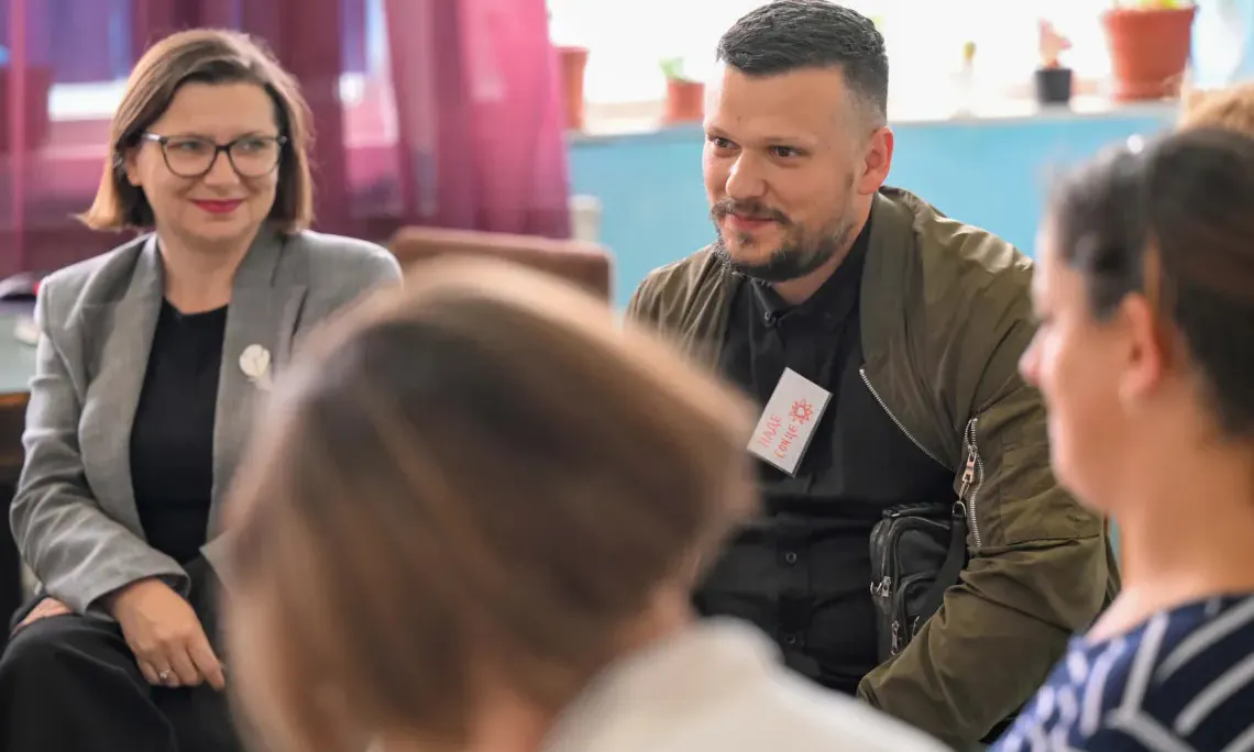 School principal Biljana Temelkovska listens as participant Vladimir (father) contributes to a group discussion during a parenting programme session.