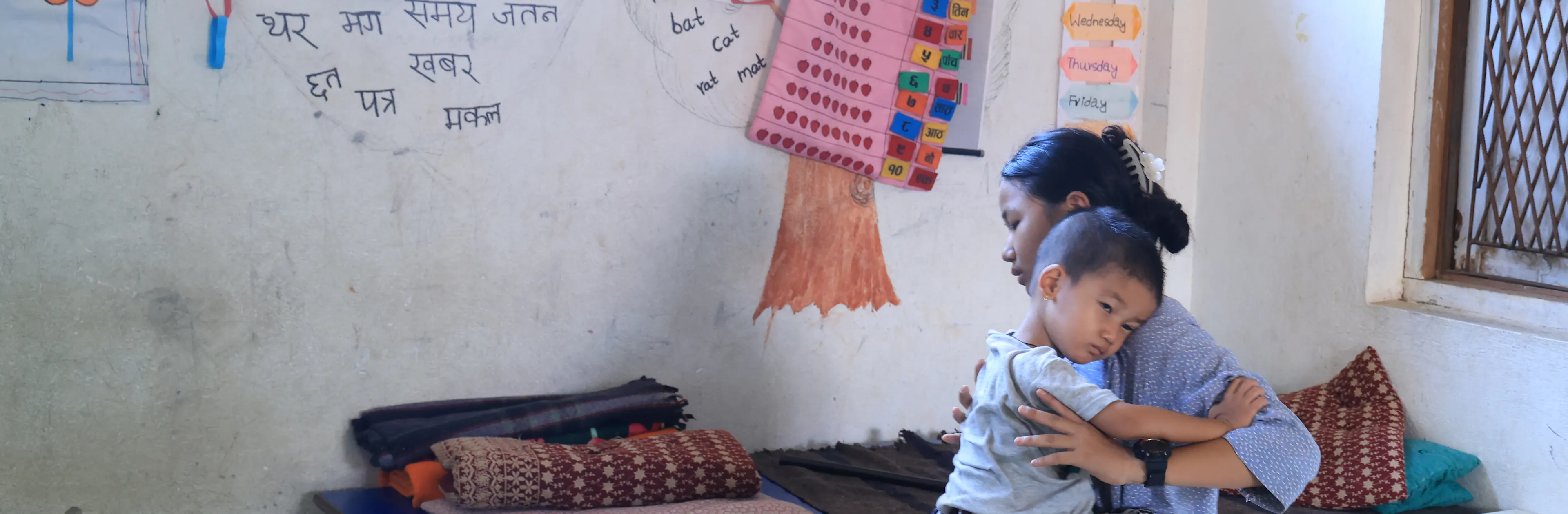 13 year old Sonika holding her 3 year old brother after devastating floods hit Nepal