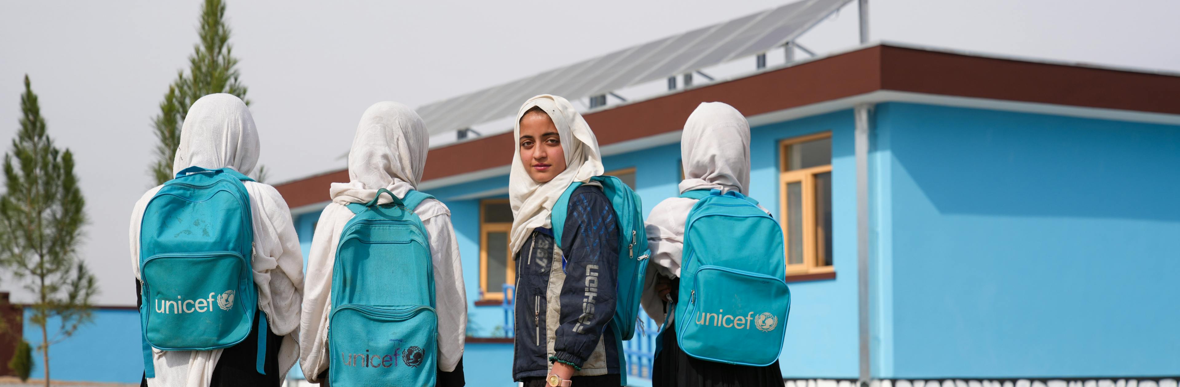 February 19, 2025 Asya, 12, (center, looking at the camera) enjoys the new school environment with her classmates in Nazyan Jalalabad province.