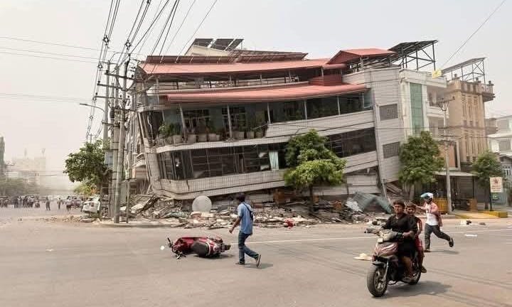 A multi-story commercial building tilts dramatically after its foundation failed during the 7.7 magnitude earthquake that struck Myanmar on 28 March 2025.