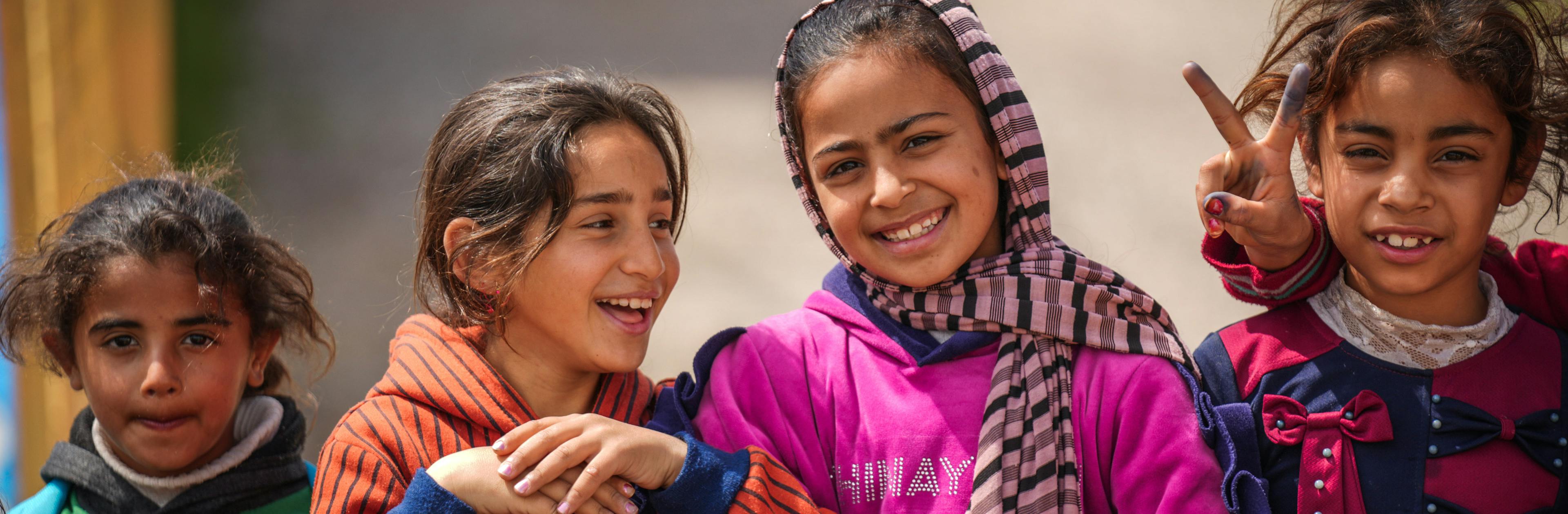 Some girls are smiling at the child protection center in Debaga camp for internally displaced people, Erbil, Iraq, 2024.