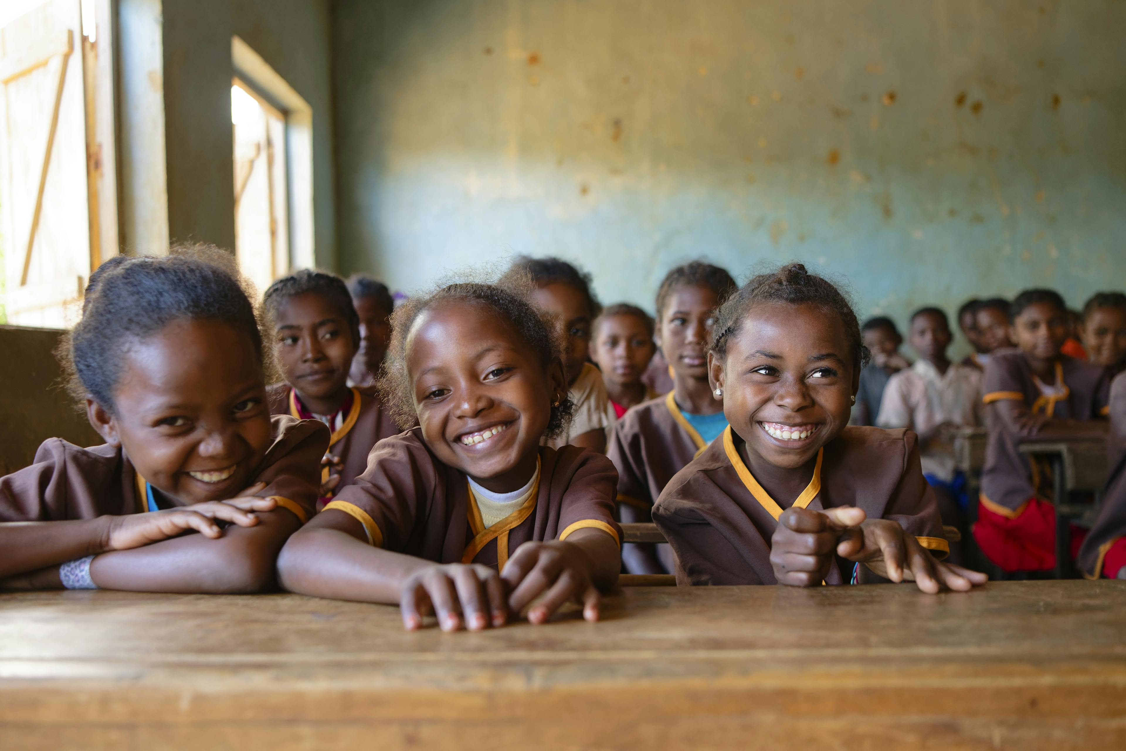 A group photo of smiling schoolgirls in their classroom at Mahatsara Sud Primary Public School, Mananjary District, Vatovavy Region, Madagascar