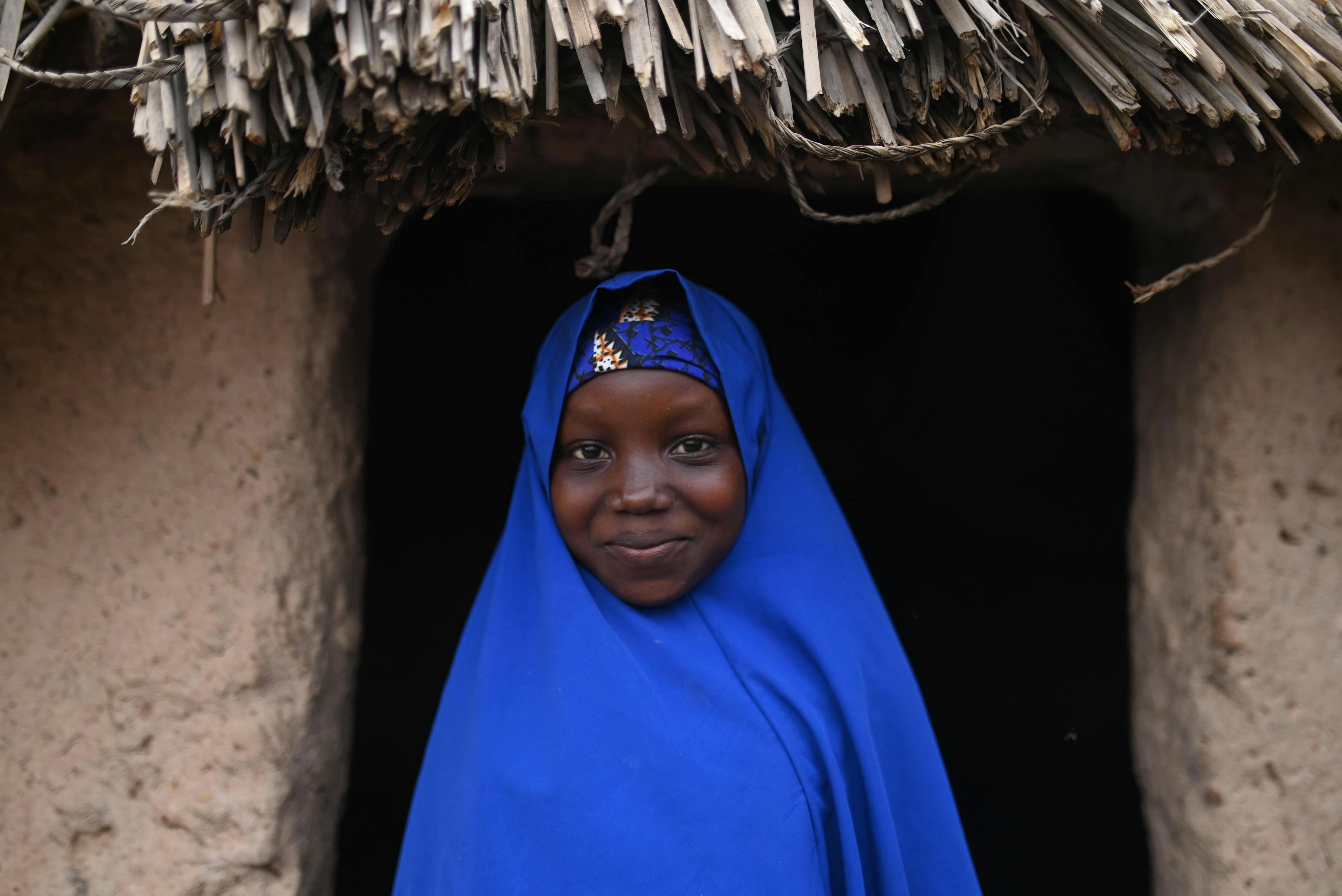 Nusaiba Lawali 13, Pose for a portrait Infront of her great grand mother’s hut in Tsalibawa Village, Sokoto state, Nigeria.