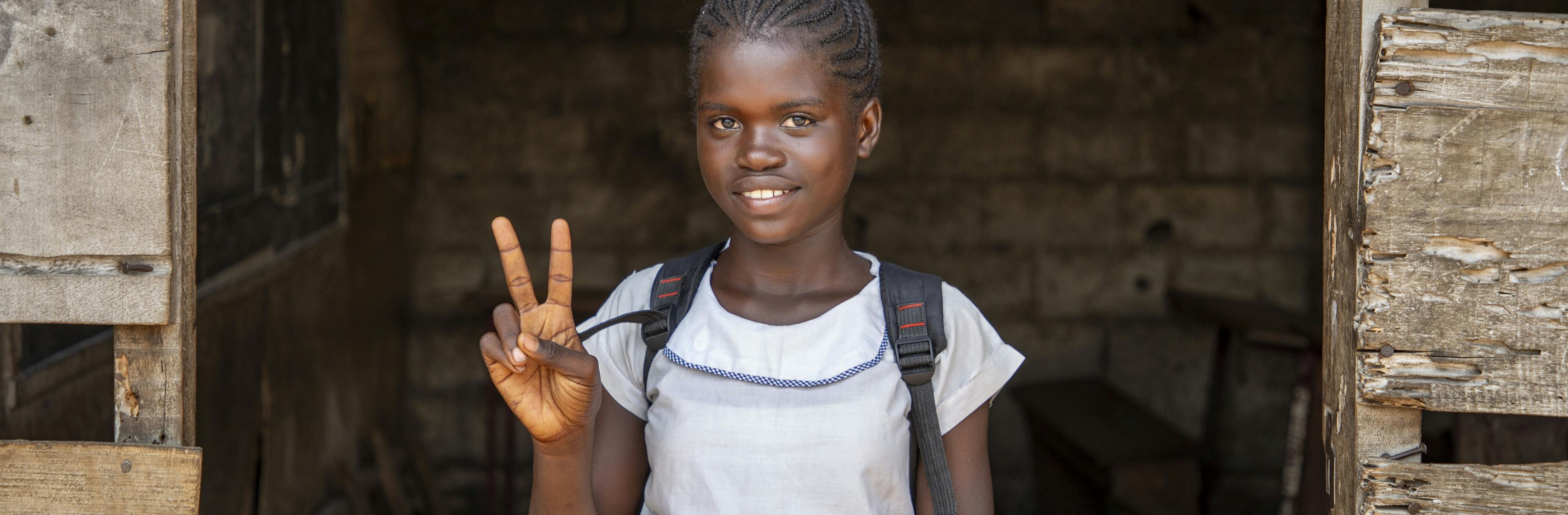 Ketsia Peme, 11, stands in the doorway of her classroom at Saint Raphaël School in Kinshasa, DR Congo, on November 6, 2024.