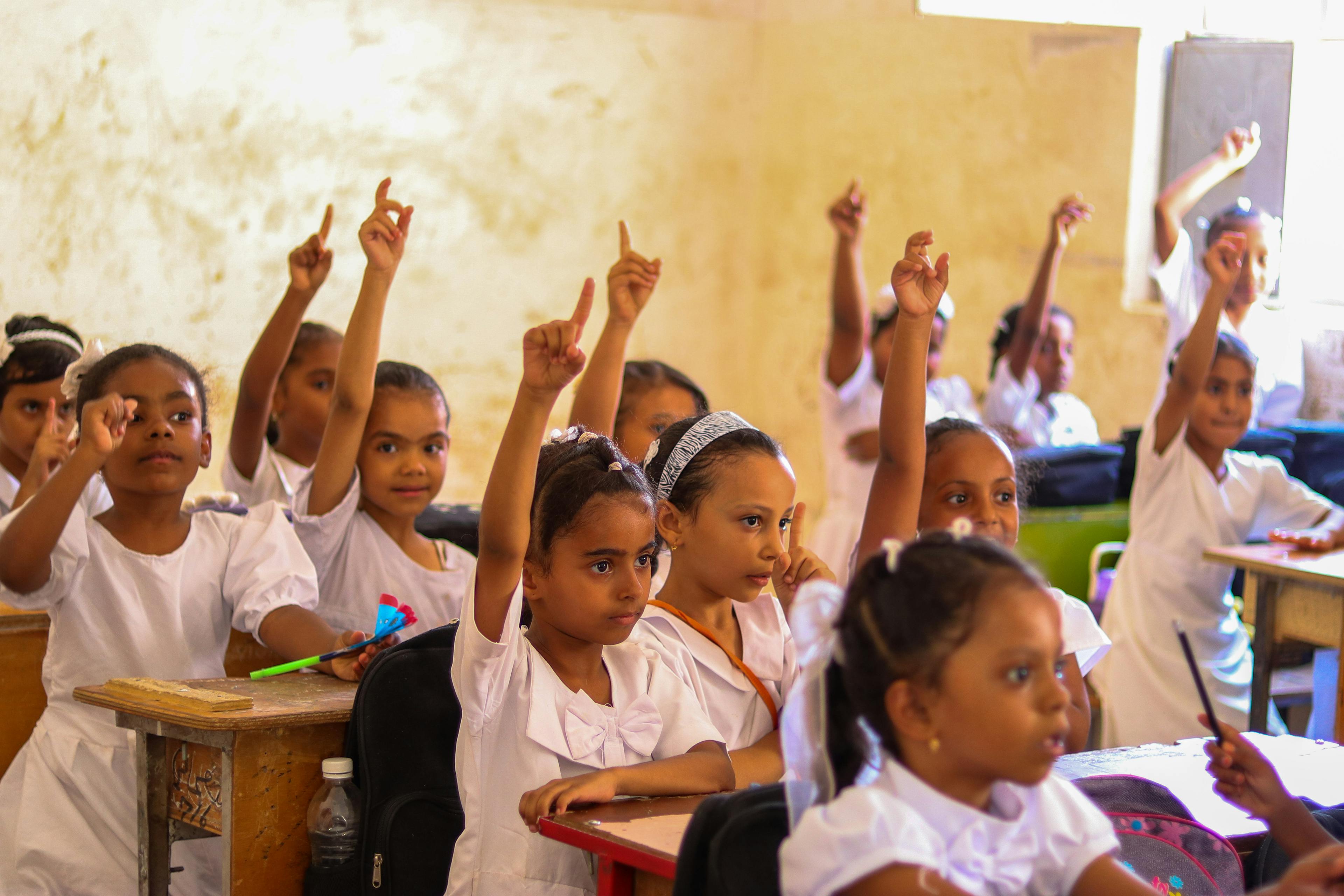 Young girl students engage enthusiastically with the day's numeracy lesson led by teacher Ghania, in Yemen.