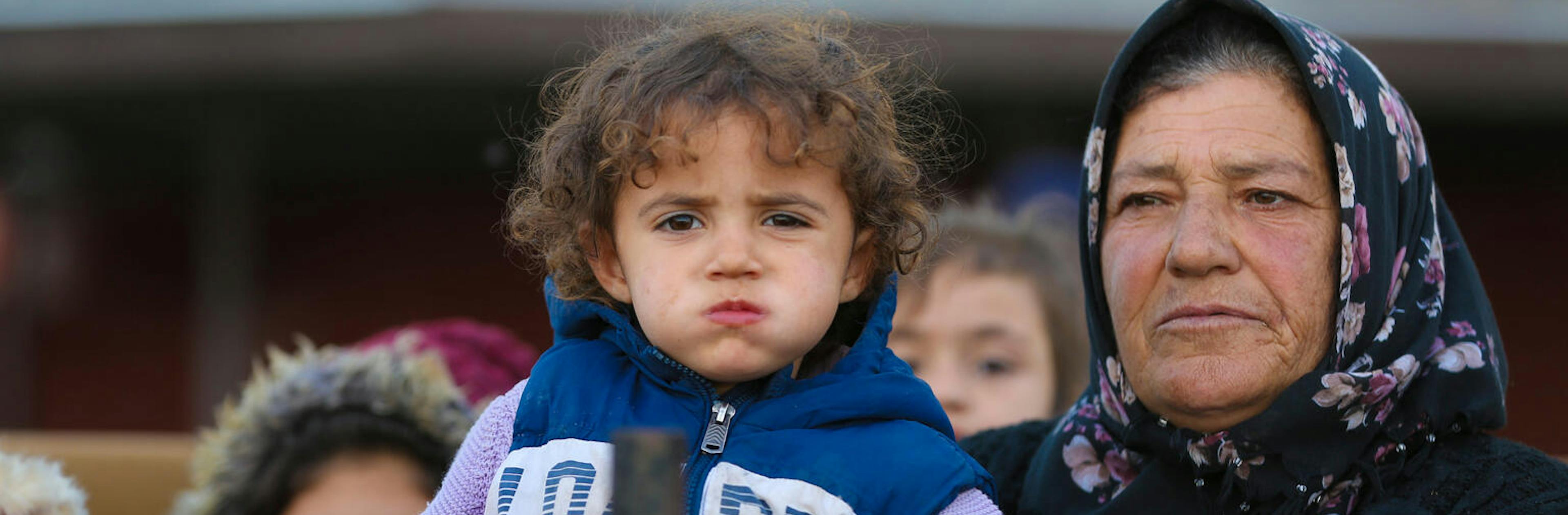 Families arriving at a reception centre in Ar-Raqqa city, Syria, on 4 December 2024, after fleeing the escalating violence in Aleppo