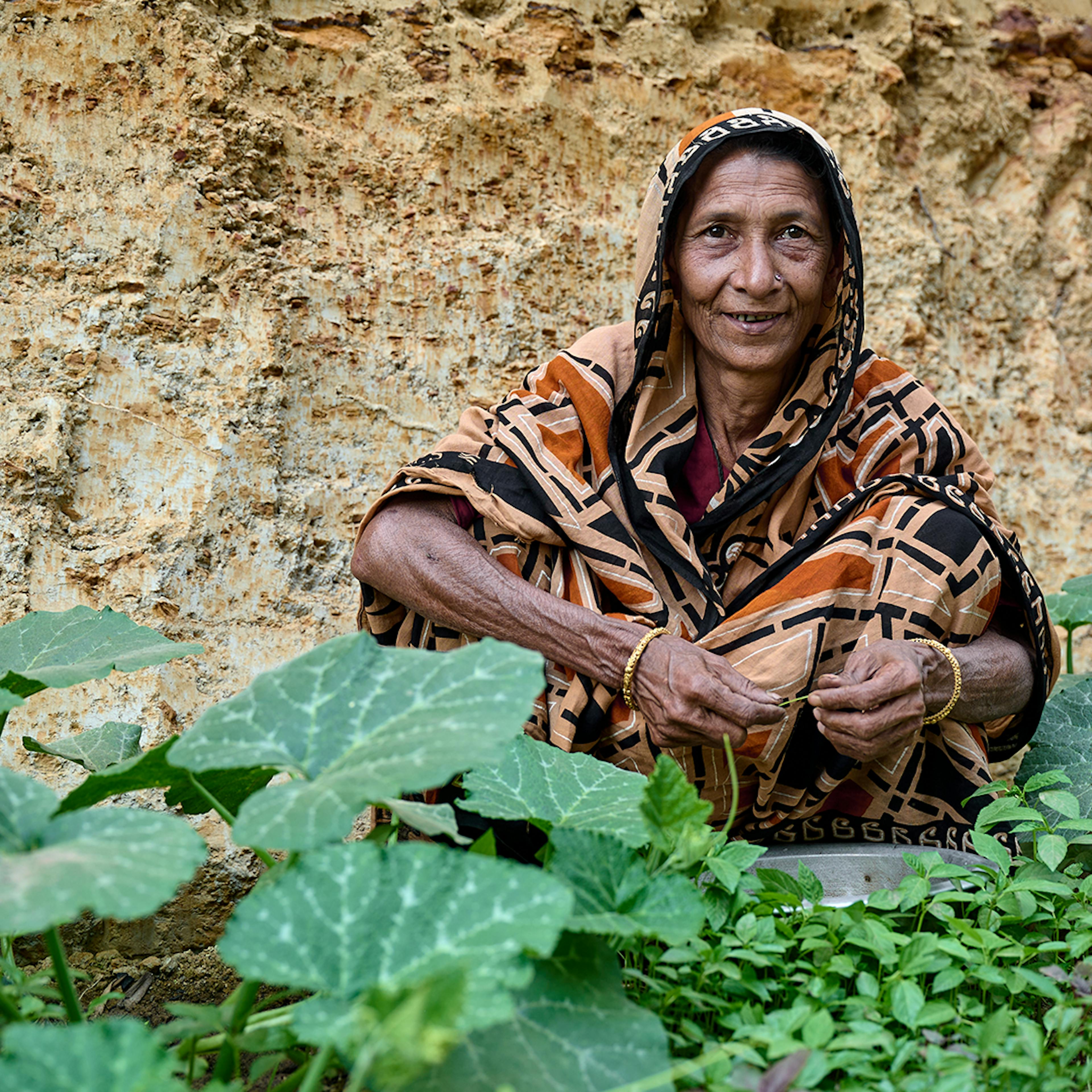 Uttar Porania Para, Cox's Bazar District, 6 March 2023: Altaj Begum (50) showing off the produce grown from her homestead garden.