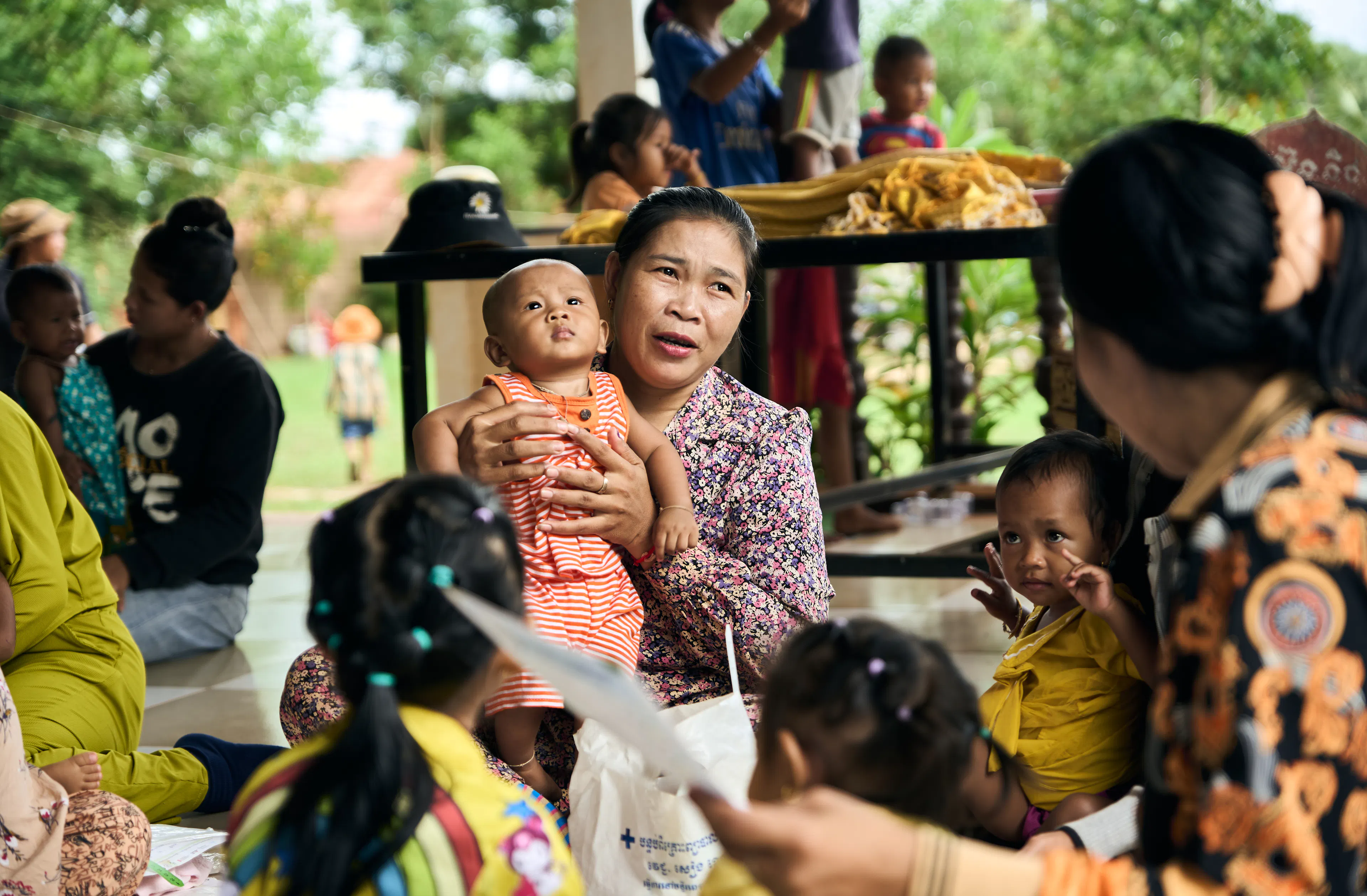 Babies, children and caregivers at the community-based health centre getting their regular health check ups in a high risk village in the Siem Reap region. UNICEF's community outreach nutrition and health programme aims to prevent children becoming malnourished by identifying any issue before it becomes severe. 