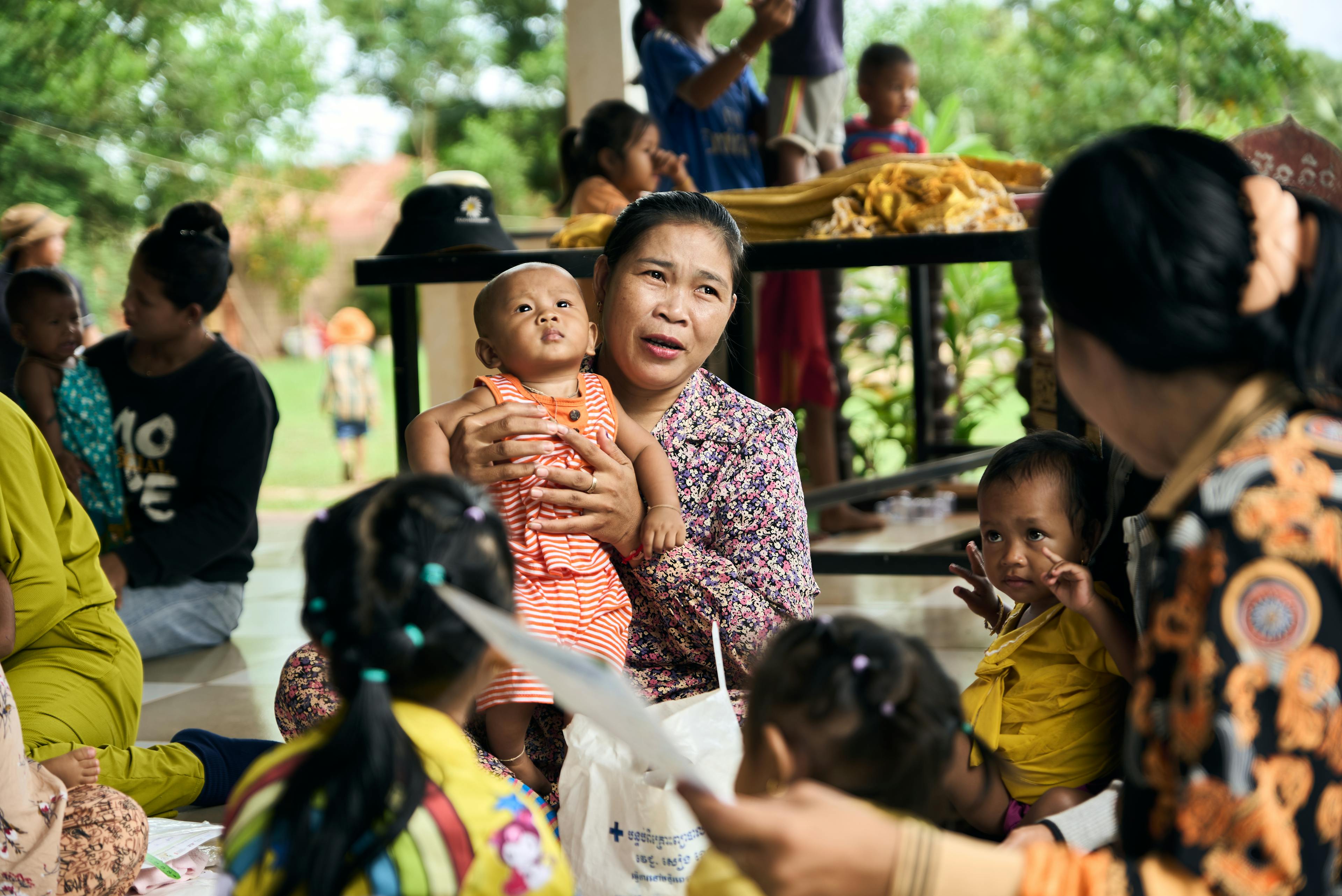 Babies, children and caregivers at the community-based health centre getting their regular health check ups in a high risk village in the Siem Reap region. UNICEF's community outreach nutrition and health programme aims to prevent children becoming malnourished by identifying any issue before it becomes severe. 