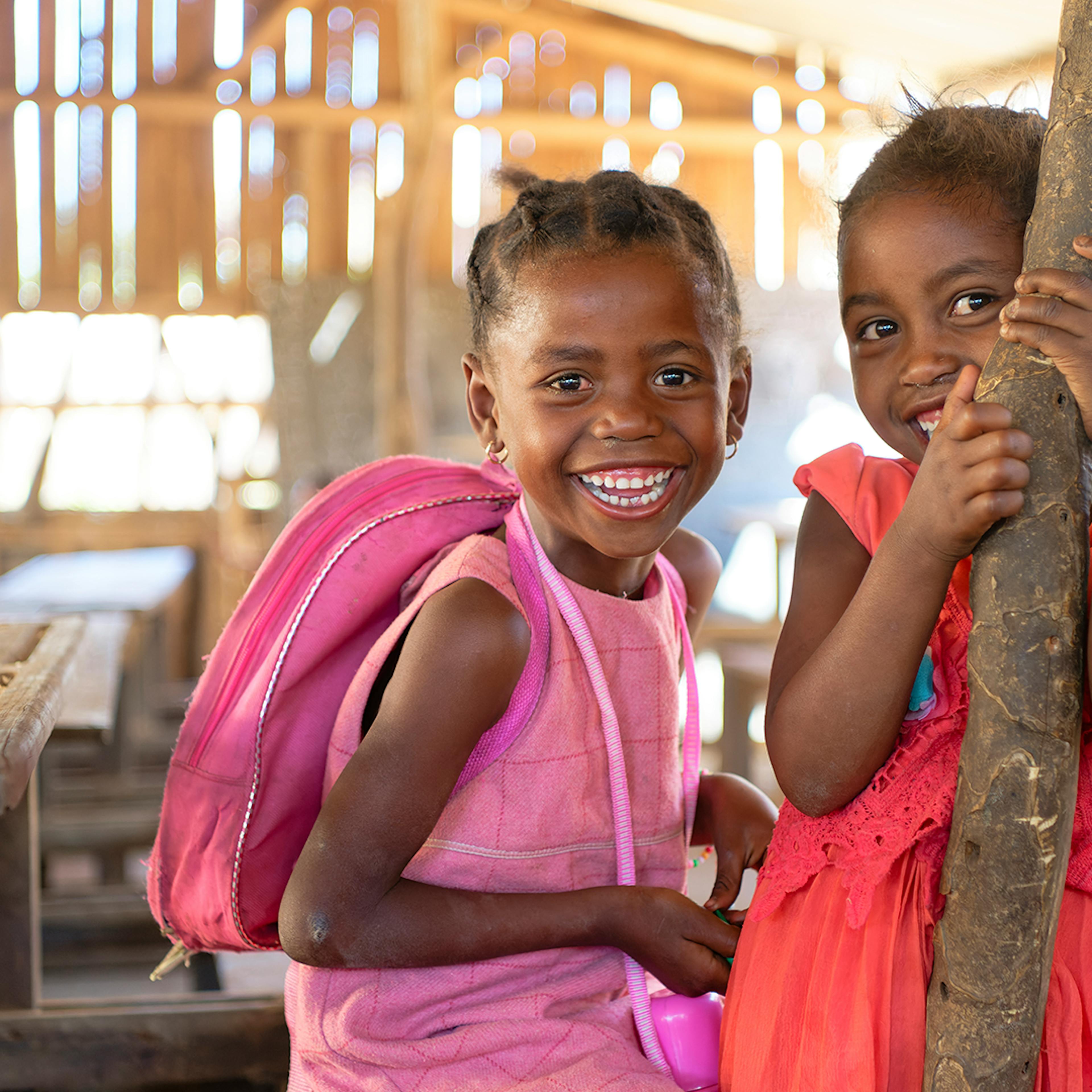 October 14, 2024 : Ambondro Primary Public School, Commune of Ambondro, Ambovombe District, Androy Region, Madagascar : portrait of two smiling schoolgirls taken in their canteen.