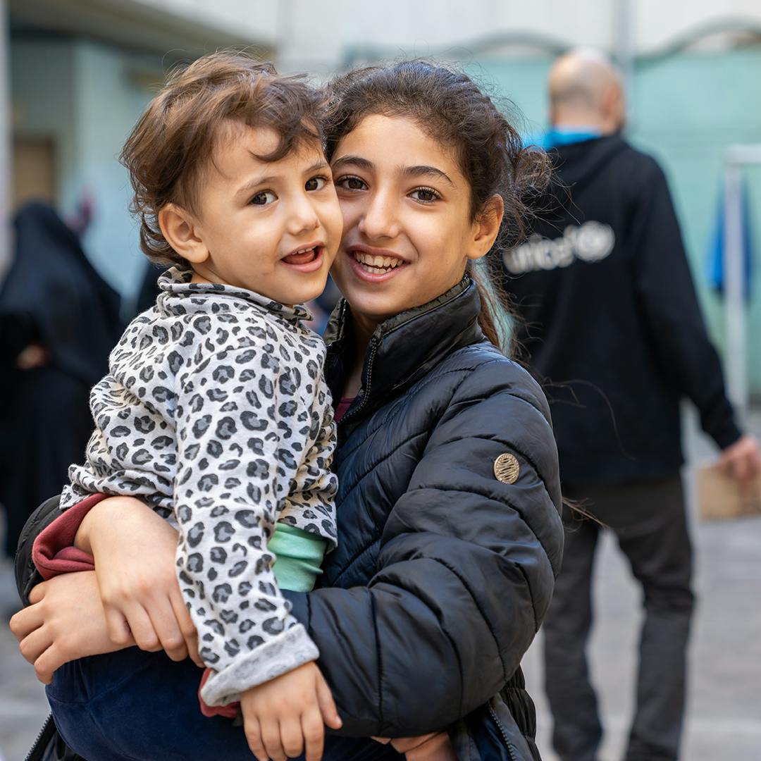 Hawraa, 3 years old with her sister Zeinab, 11 years old.