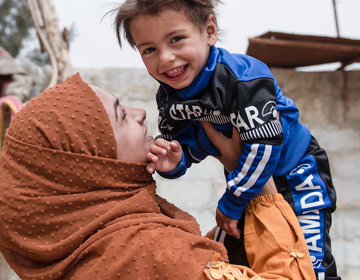 Abir, 22, holds her son Ishak, 1.5 years, in their house in Jarba village of East Ghouta, Rural Damascus, Syria, on 3 April 2022.