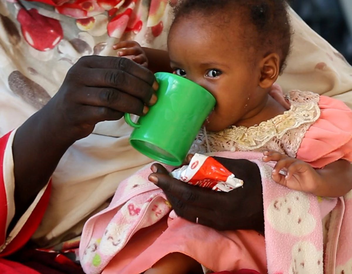 7-months-old Genan eats read-to-use-therapeutic food, during a visit to Damazine Children's hospital in Damazine, Blue Nile state, where she is admitted on a nutrition programme for treatment of malnutrition.