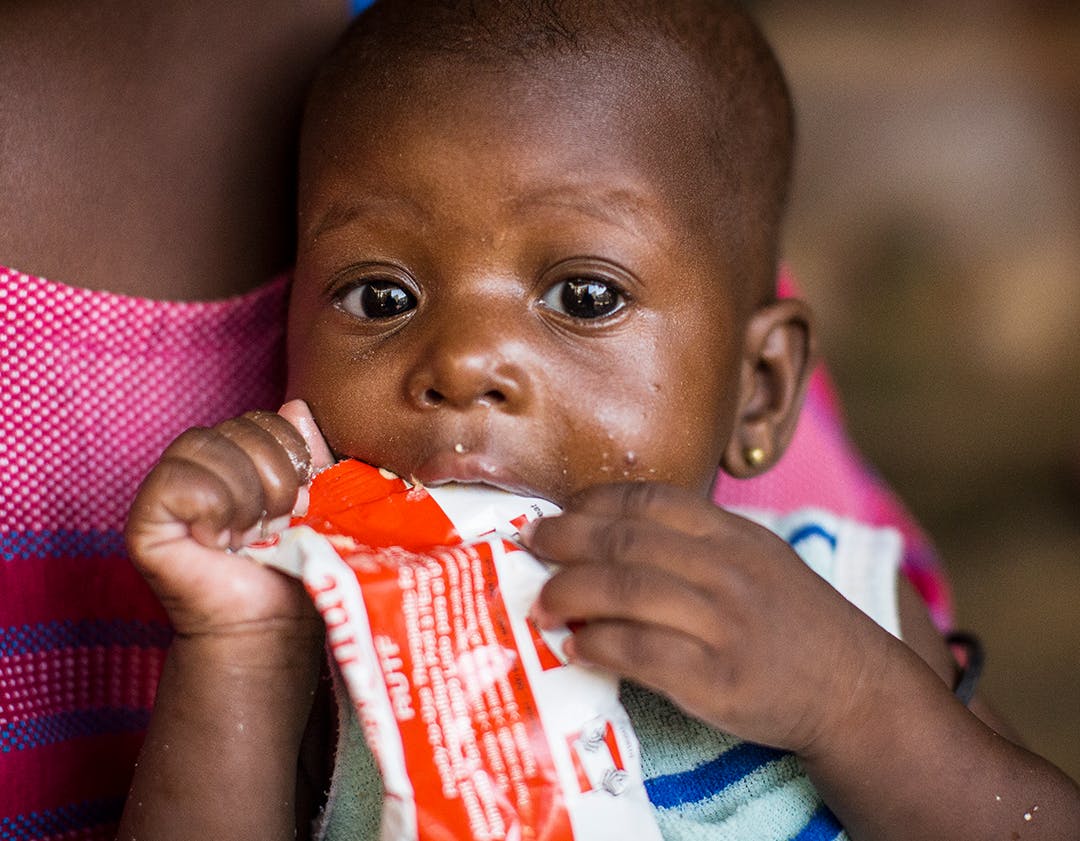 On 22 October 2019 in Mopti, Mali, 6-month-old Aissata Kanitao eats a Ready-to-Use Therapeutic Food (RUTF) pack.