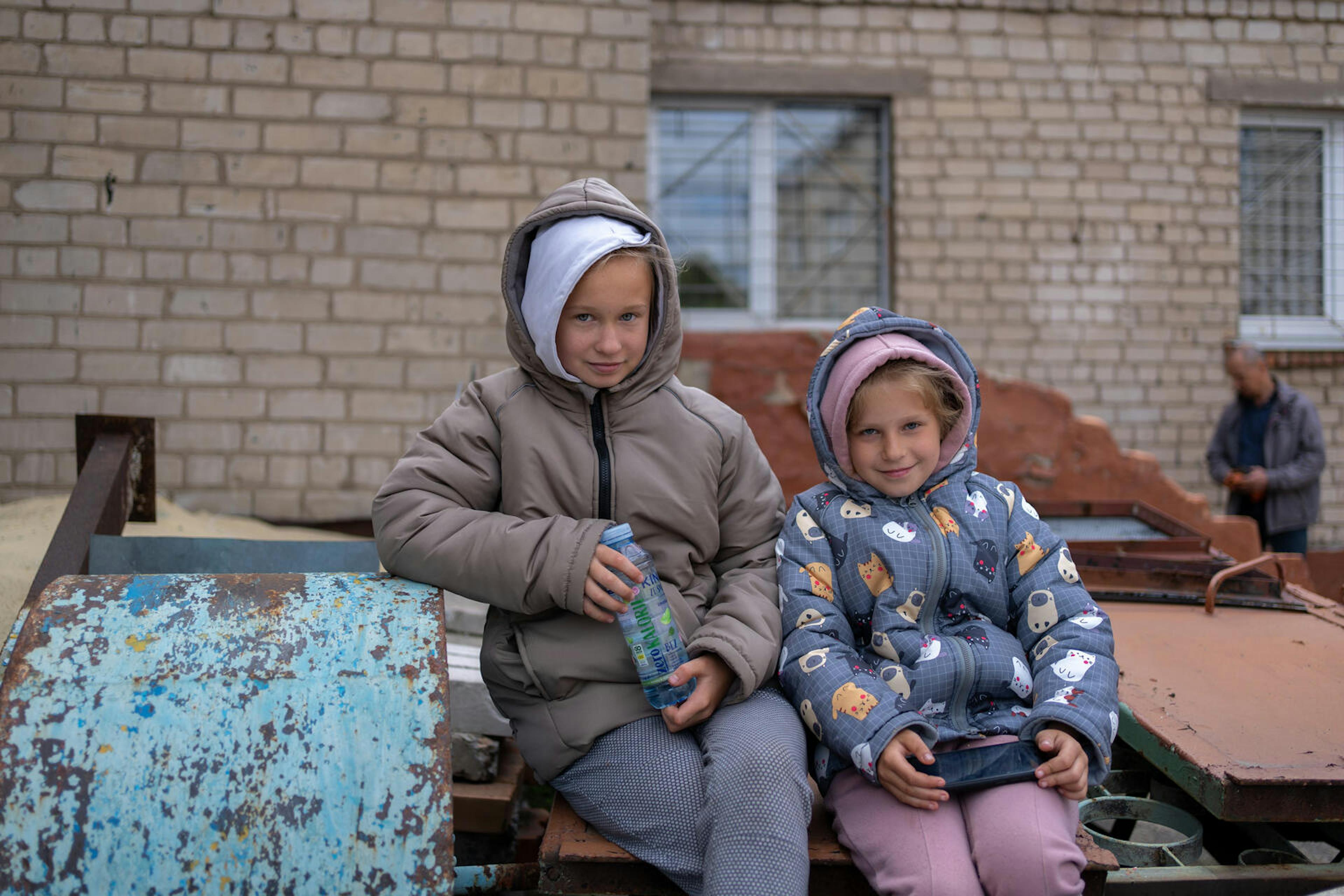 Yulia (7) and Stanislava (10) in their newly received winter clothes at a UNICEF distribution centre.