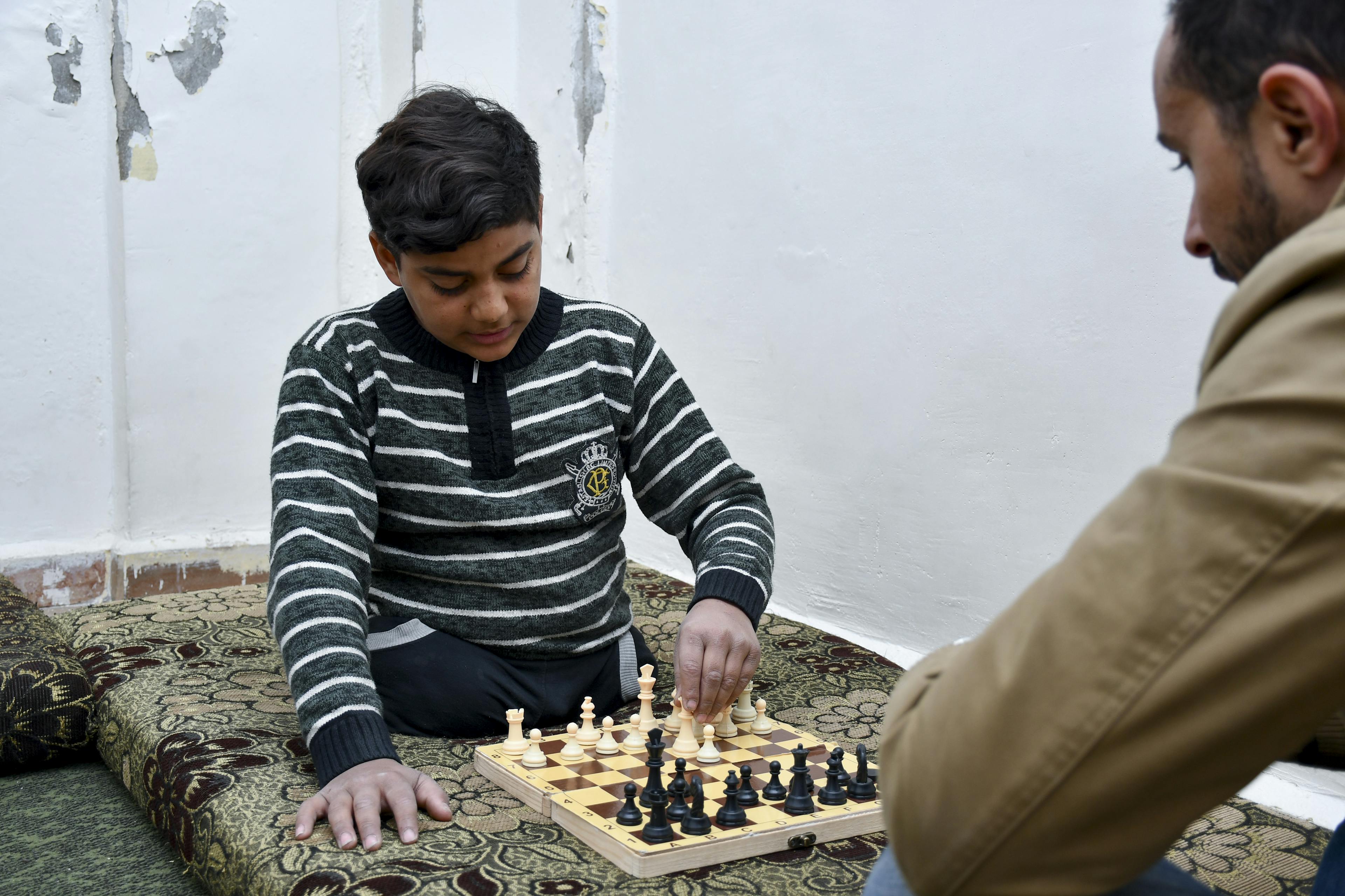 ahia, 13, plays chess with a member of a UNICEF-supported team at his home in Zabadin village, Rural Damascus, Syria, on 3 February 2025.