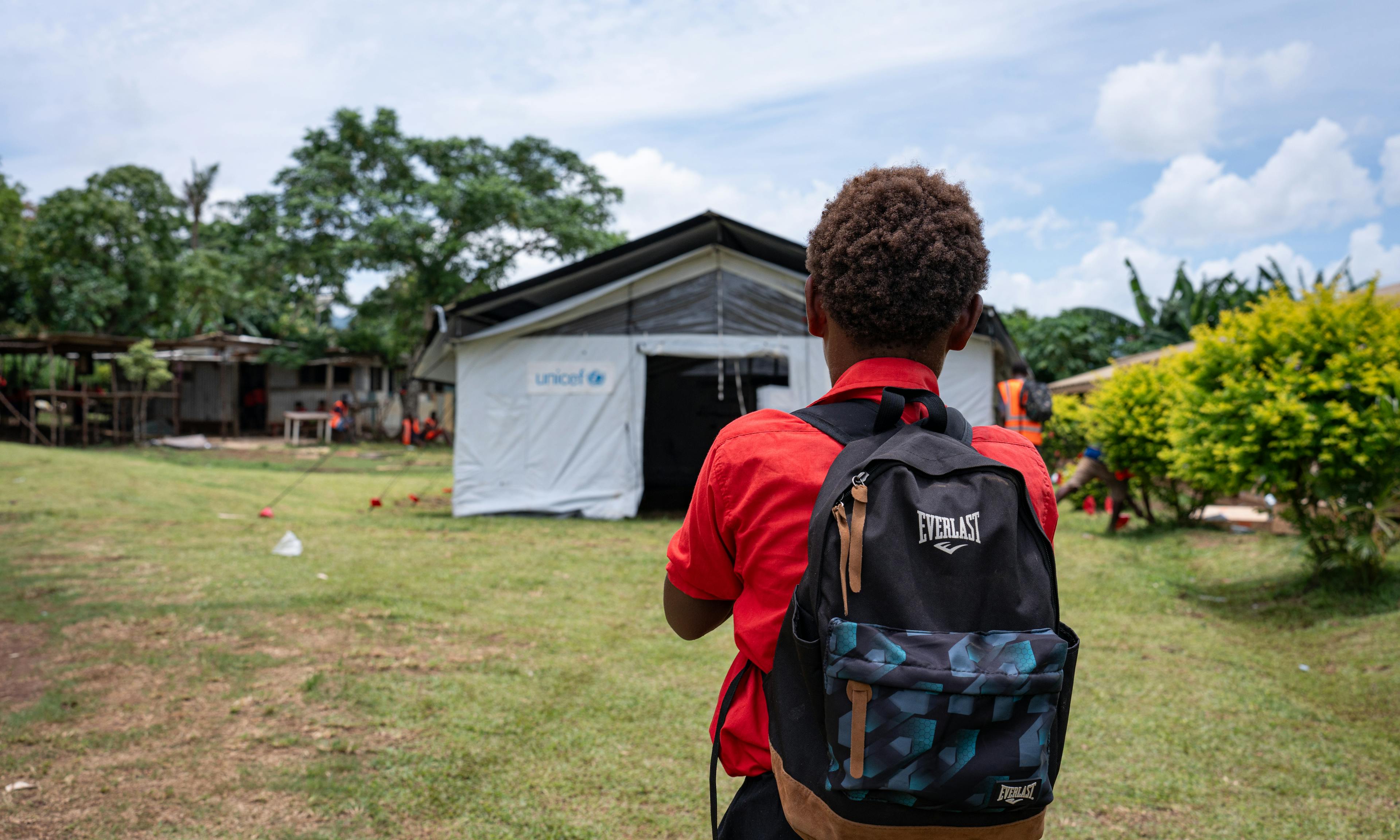 A student from Survival School inspects a tent set up by UNICEF staff and Red Cross volunteers as a temporary classroom after the December 17th earthquake damaged the school's buildings at Fresh Water Five, Efate, SHEFA, Vanuatu.