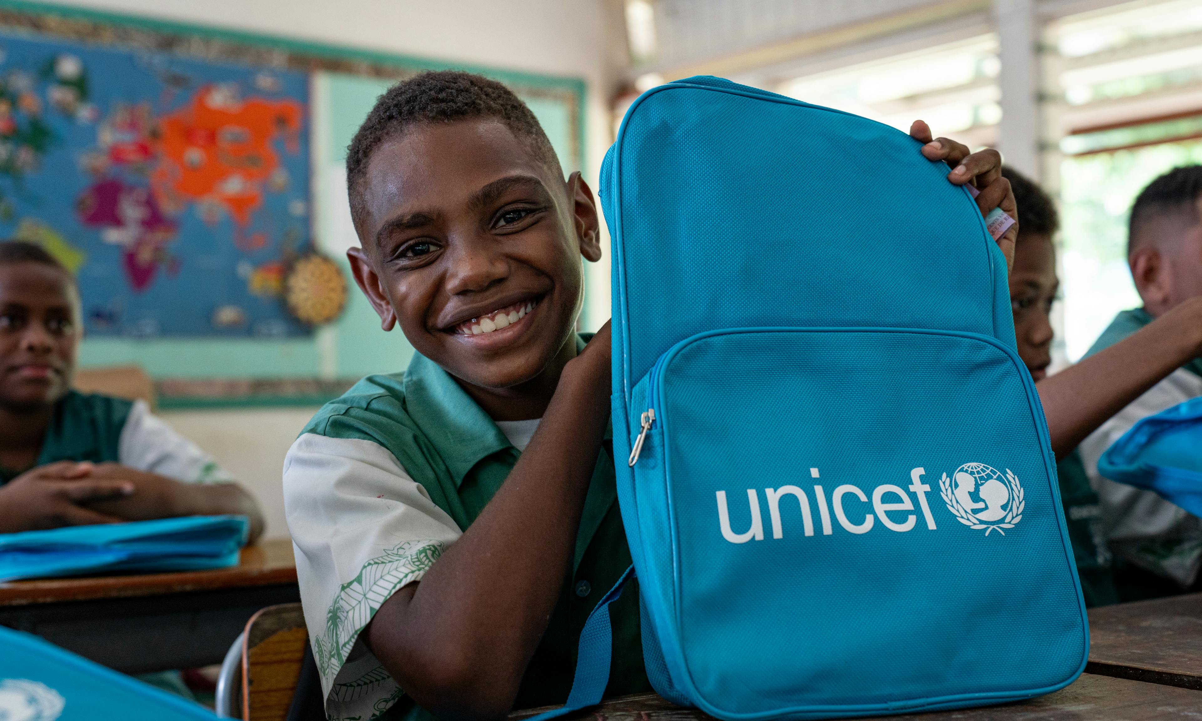 Students of Central School, Port Vila, Vanuatu with their backpacks on the second day of school. These backpacks were distributed by UNICEF staff to children affected by the recent earthquake.