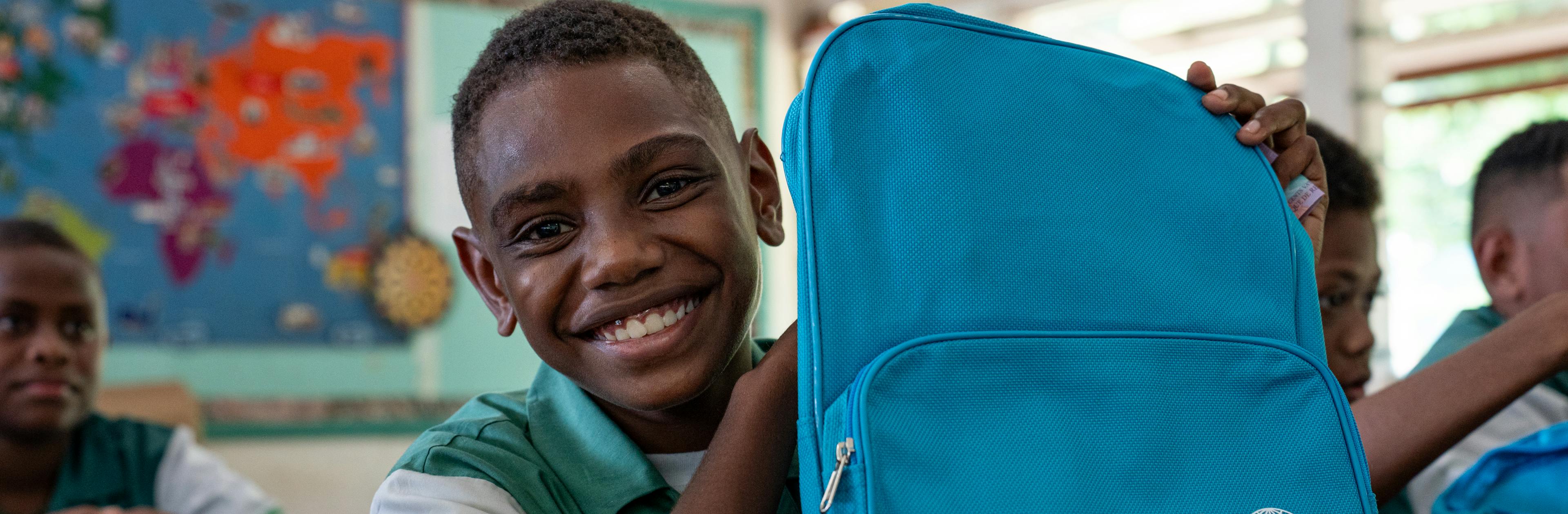 Students of Central School, Port Vila, Vanuatu with their backpacks on the second day of school. These backpacks were distributed by UNICEF staff to children affected by the recent earthquake.

