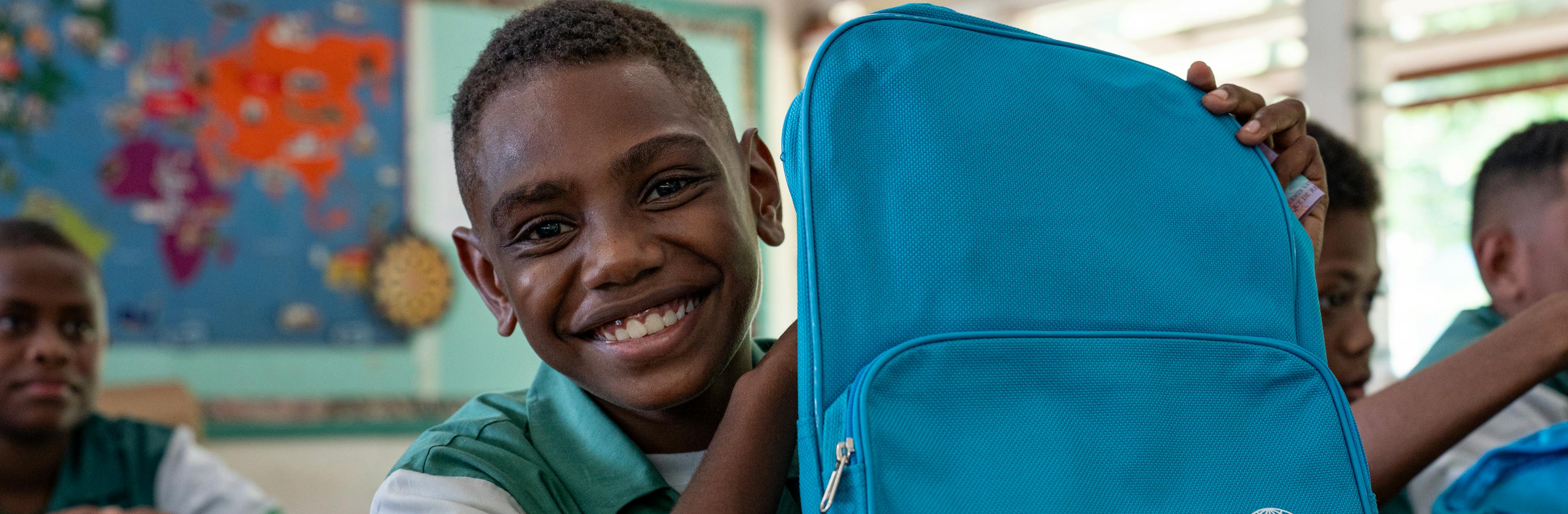 Students of Central School, Port Vila, Vanuatu with their backpacks on the second day of school. These backpacks were distributed by UNICEF staff to children affected by the recent earthquake.