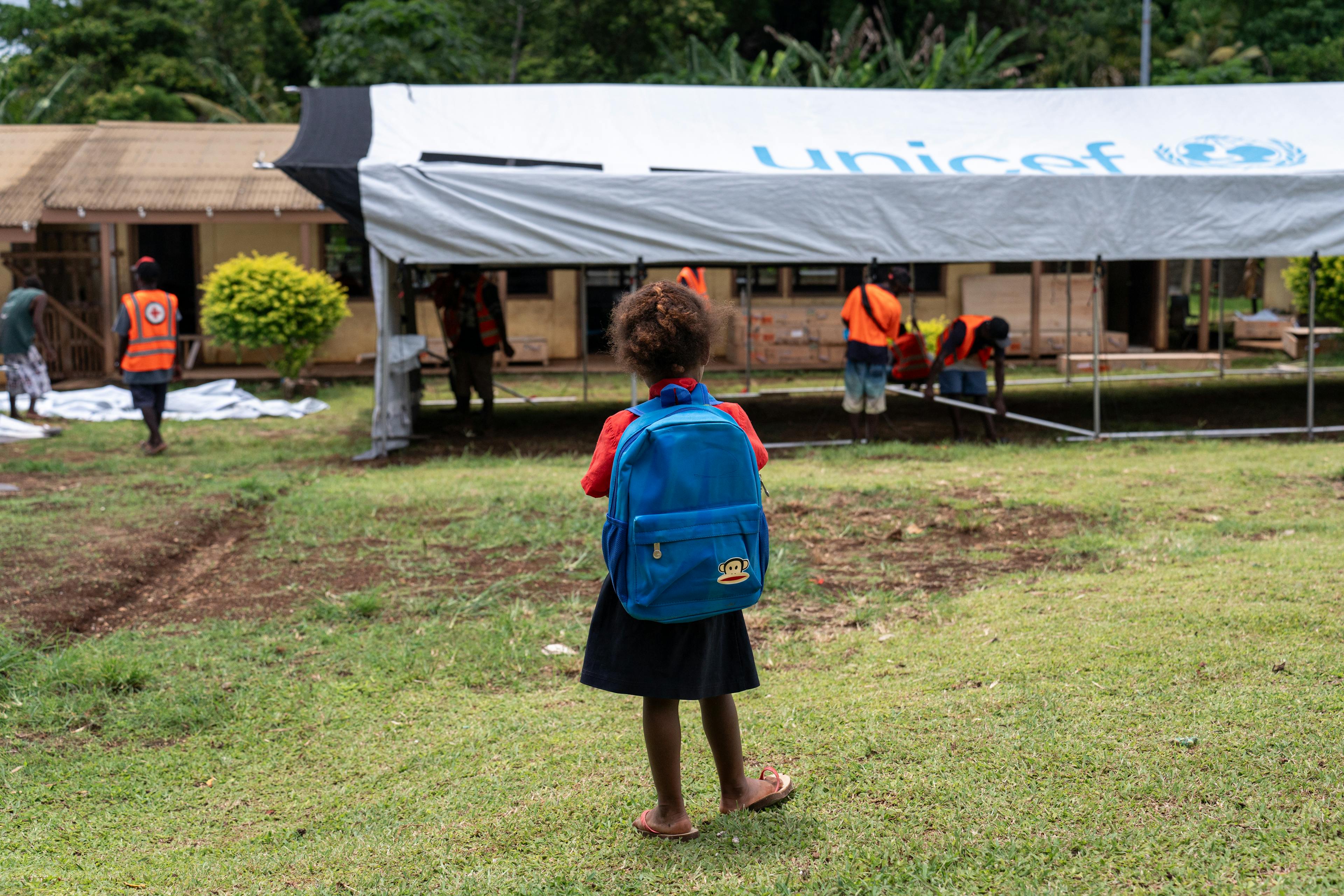 A student of Survival school looks on as UNICEF staff and Red Cross volunteers set up temporary classrooms at Survival School after it suffered damage to buildings in the December 17th earthquake at Fresh Water Five, Efate, SHEFA, Vanuatu.