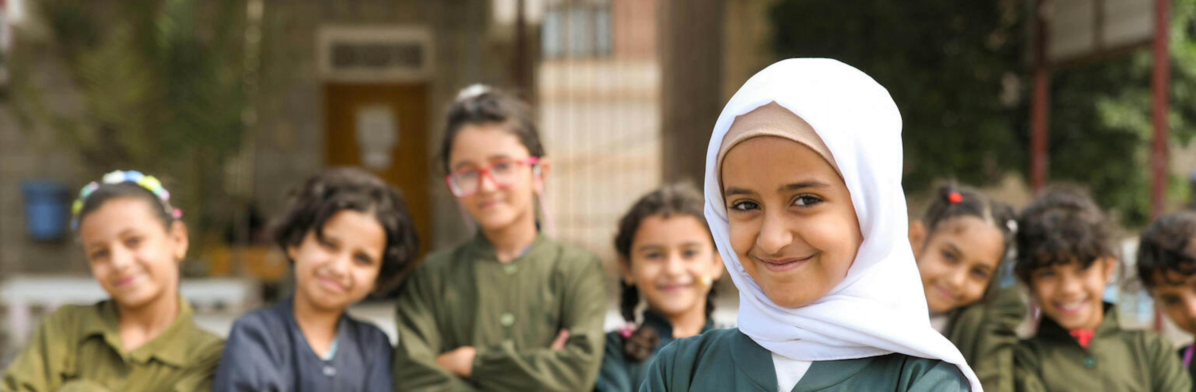 A student smiles happily in the yard of Arwa school where Back-to-School project initiated by the support of UNICEF in Sana’a governorate.